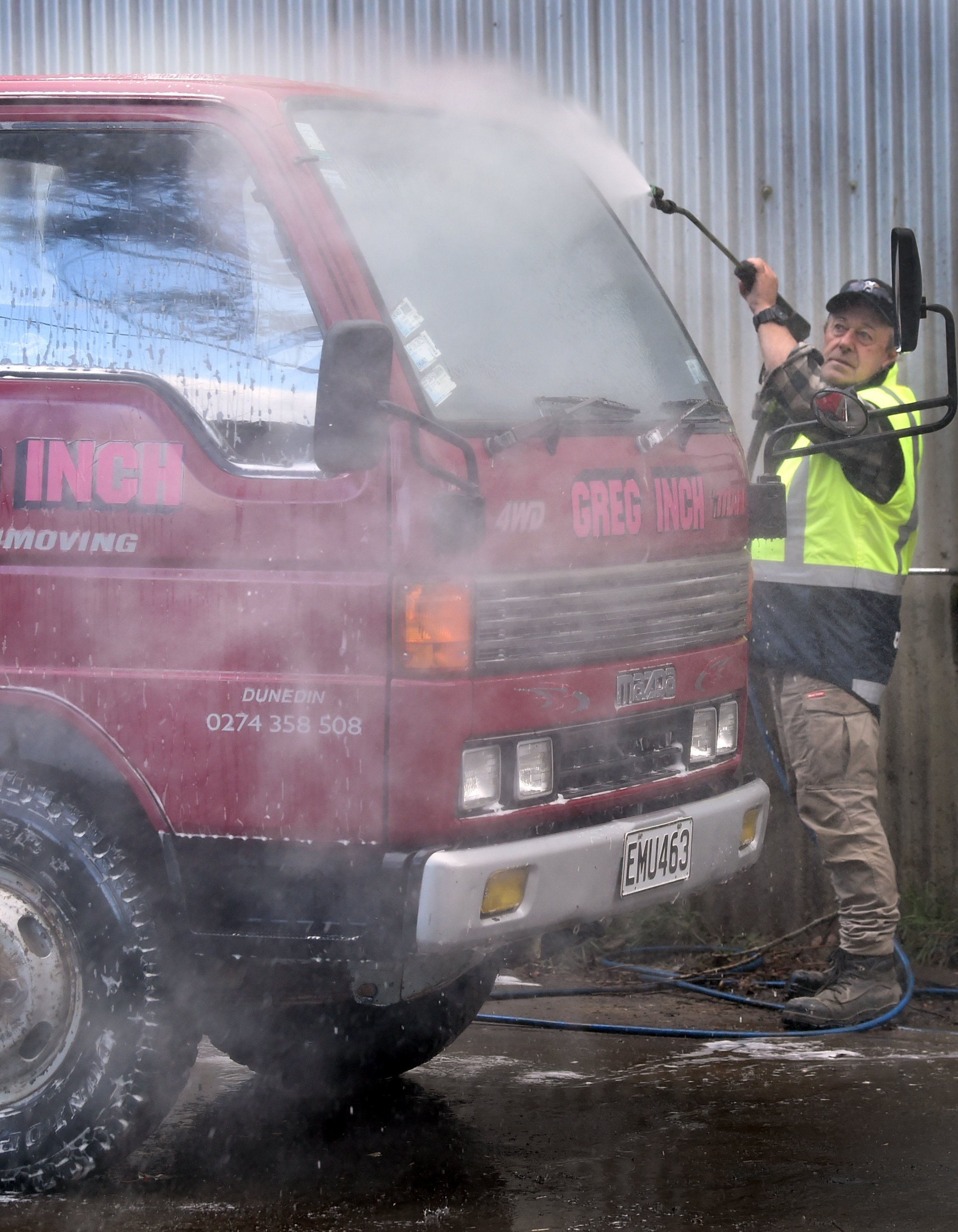 Special Rigs for Special Kids committee president Greg Inch cleans one of his trucks in...