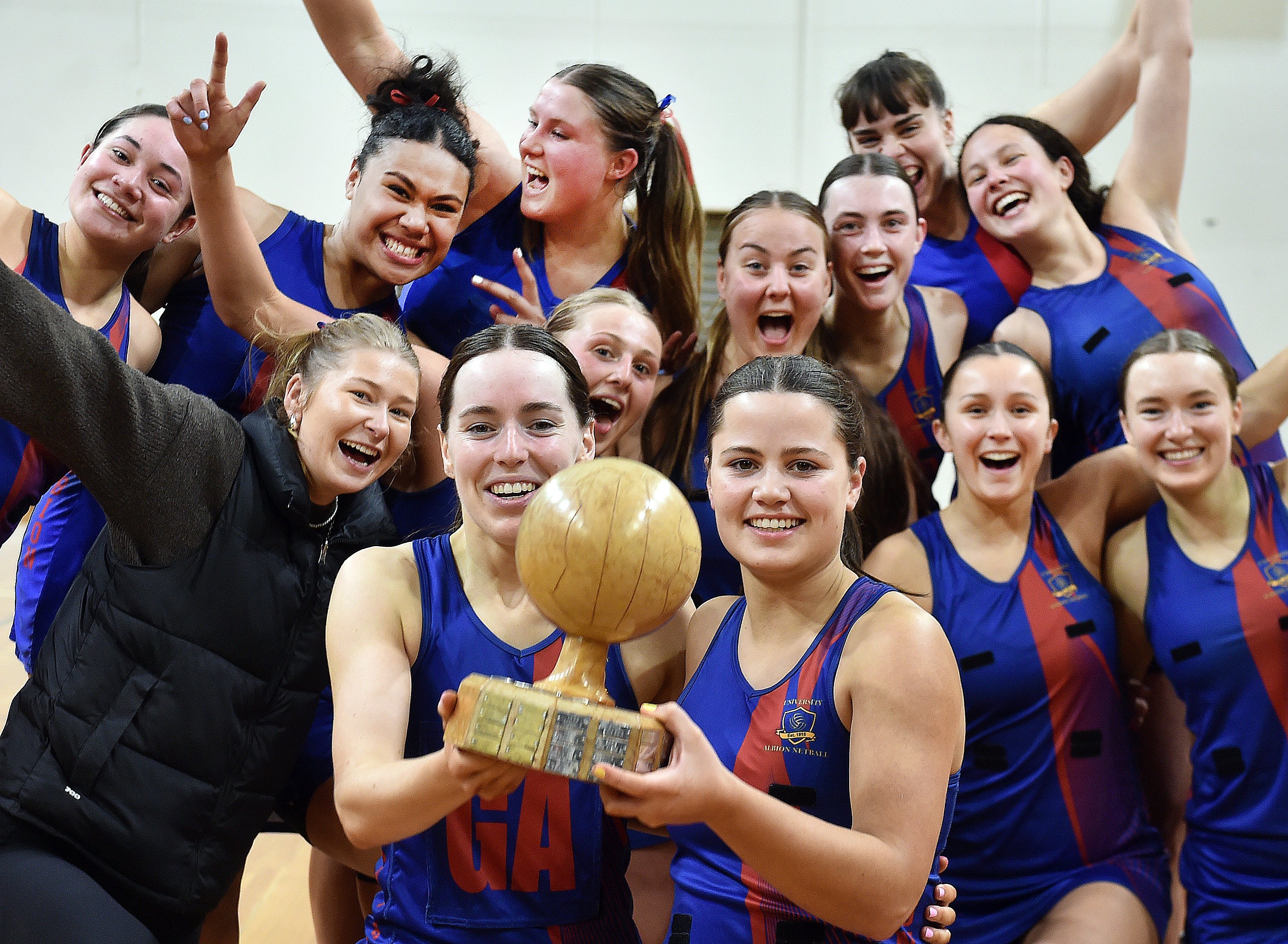 University-Albion A netballers celebrate winning a third straight Dunedin premier club title on...