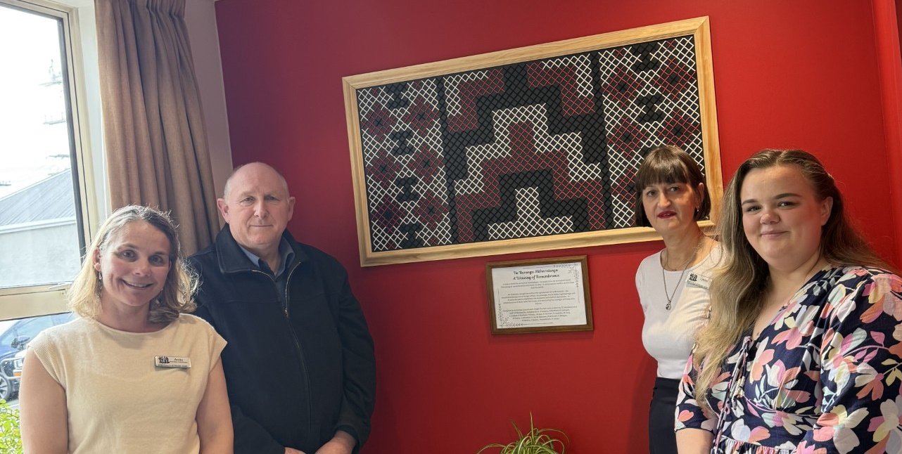 Standing beside the tukutuku panel made by Montecillo Veteran’s Home & Hospital residents, that...
