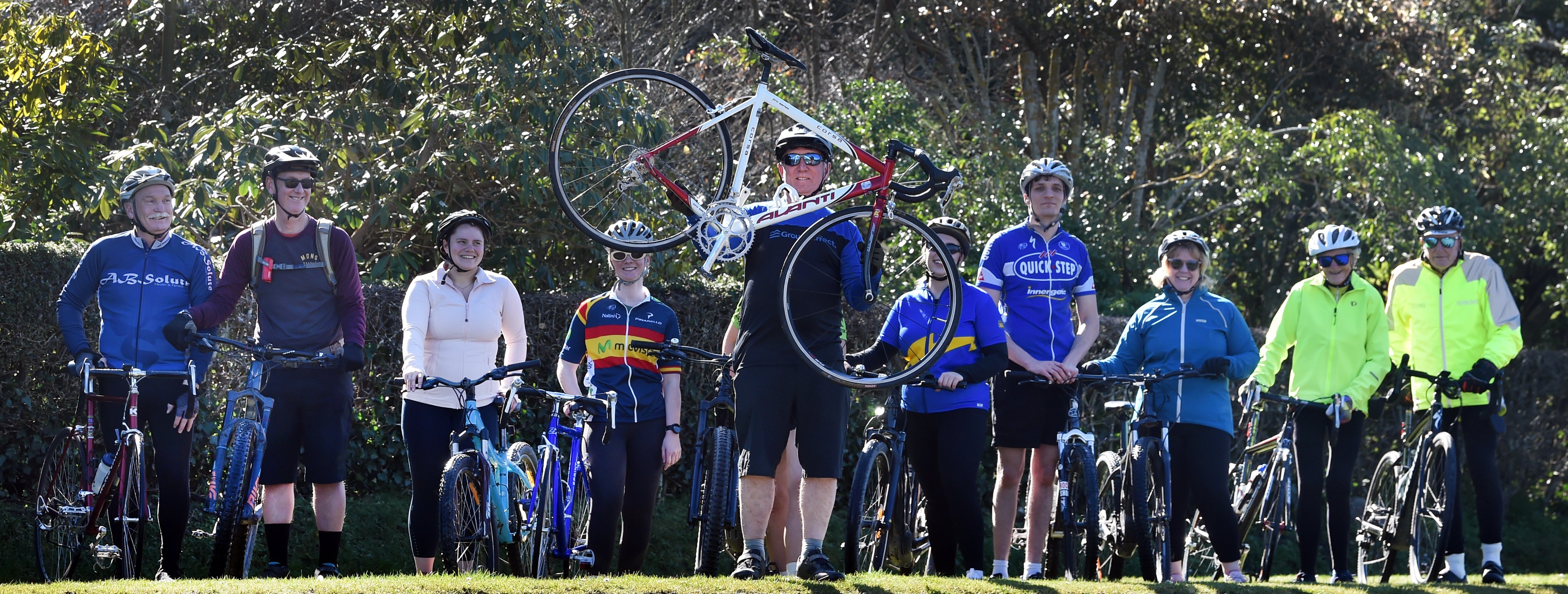 Tony Wood (front) holds the late Darren Wispinski’s Avanti road bike, during a memorial ride with...