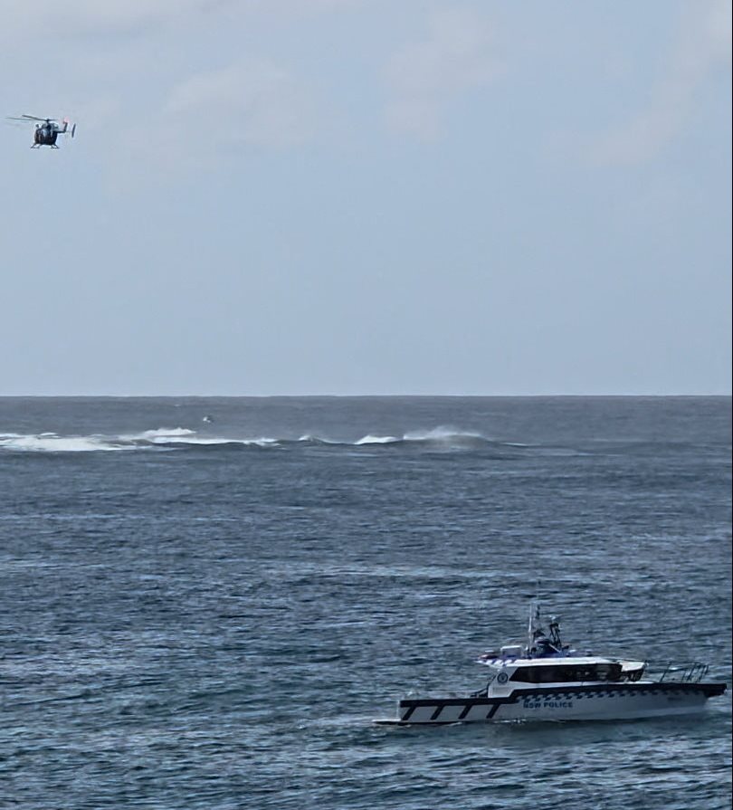 Emergency services vessels and a helicopter at Long Reef Beach where a surfer died after being...