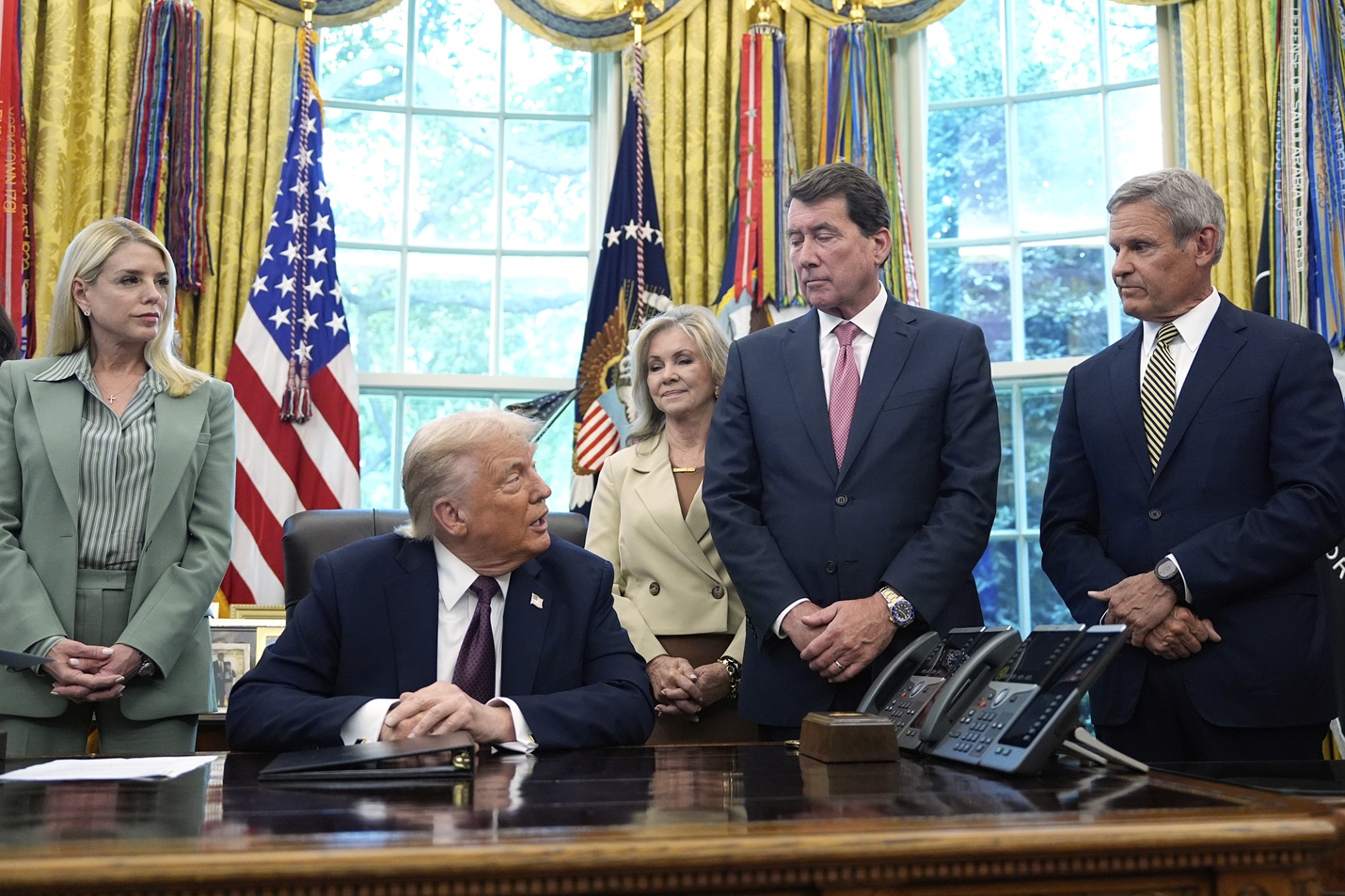 US President Donald Trump speaks as Attorney General Pam Bondi (L) and Senator Marsha Blackburn,...