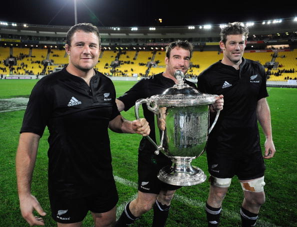 Tom Donnelly (right) carries the Bledisloe Cup alongside Tony Woodcock (left) and Andrew Hore...