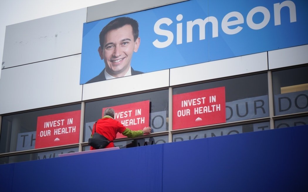 A protester outside Simeon Brown's electorate office covered the health minister's message in his...