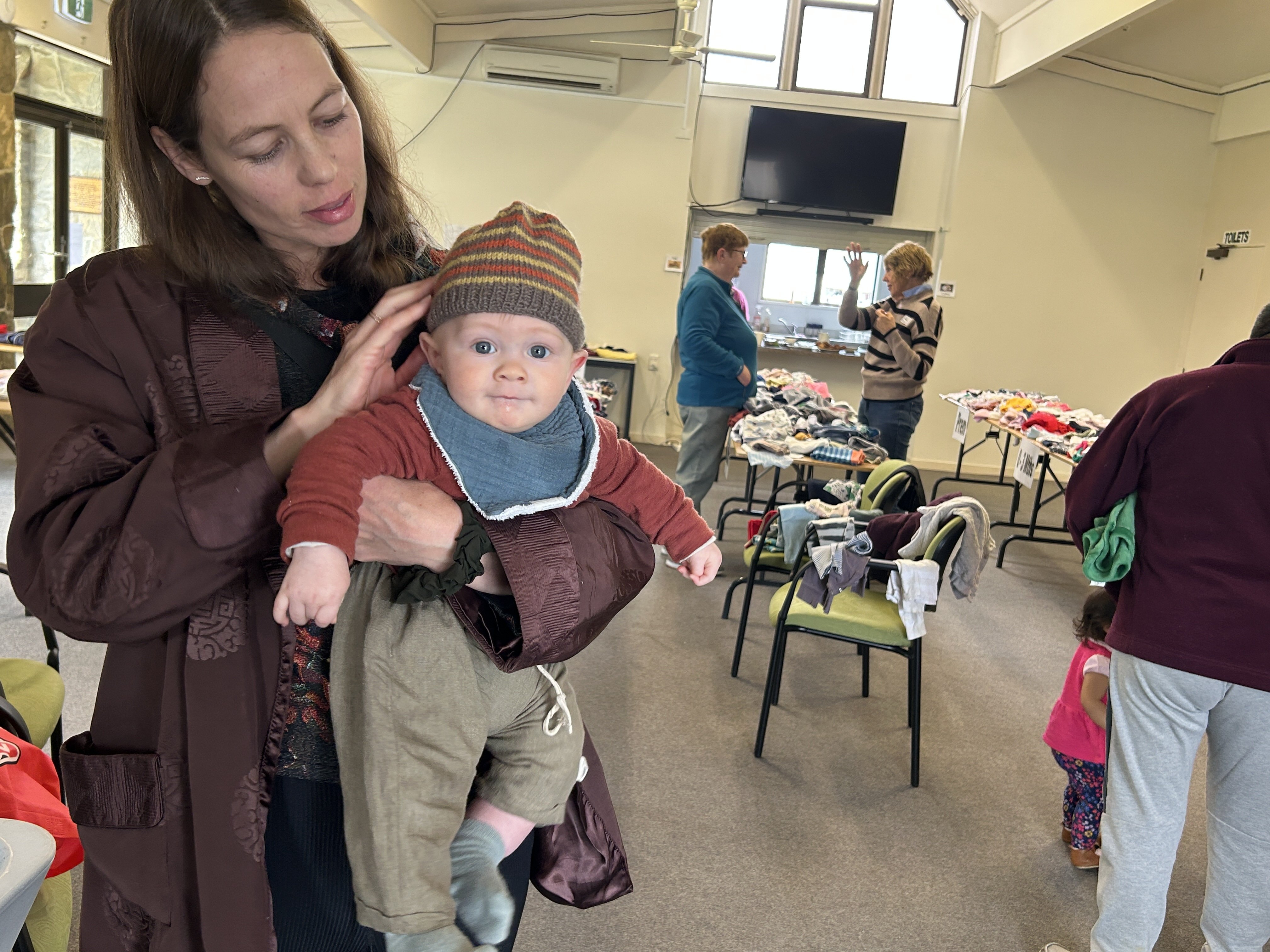 Roromata Parker-Wright and his mum Camille Parker taking part in a children's clothing swap...