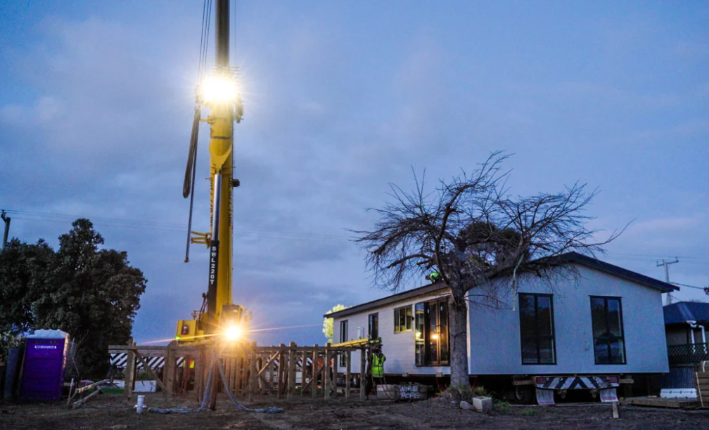 The Collins' new house is craned onto the Eskdale site. Photo: Corner Store