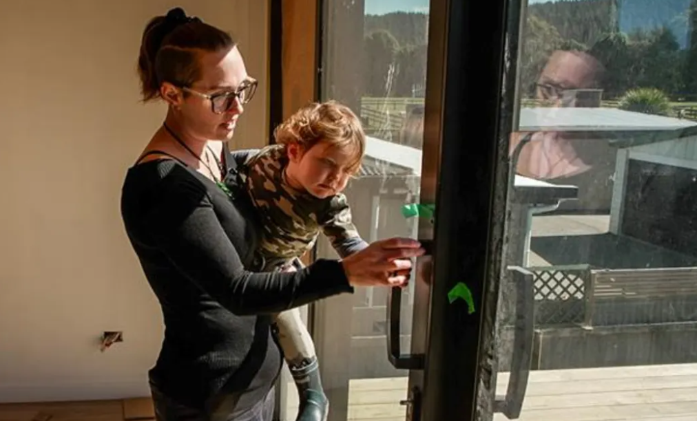 Ella Collins shows two-year-old son Jack Jnr, born after Cyclone Gabrielle, around their new...