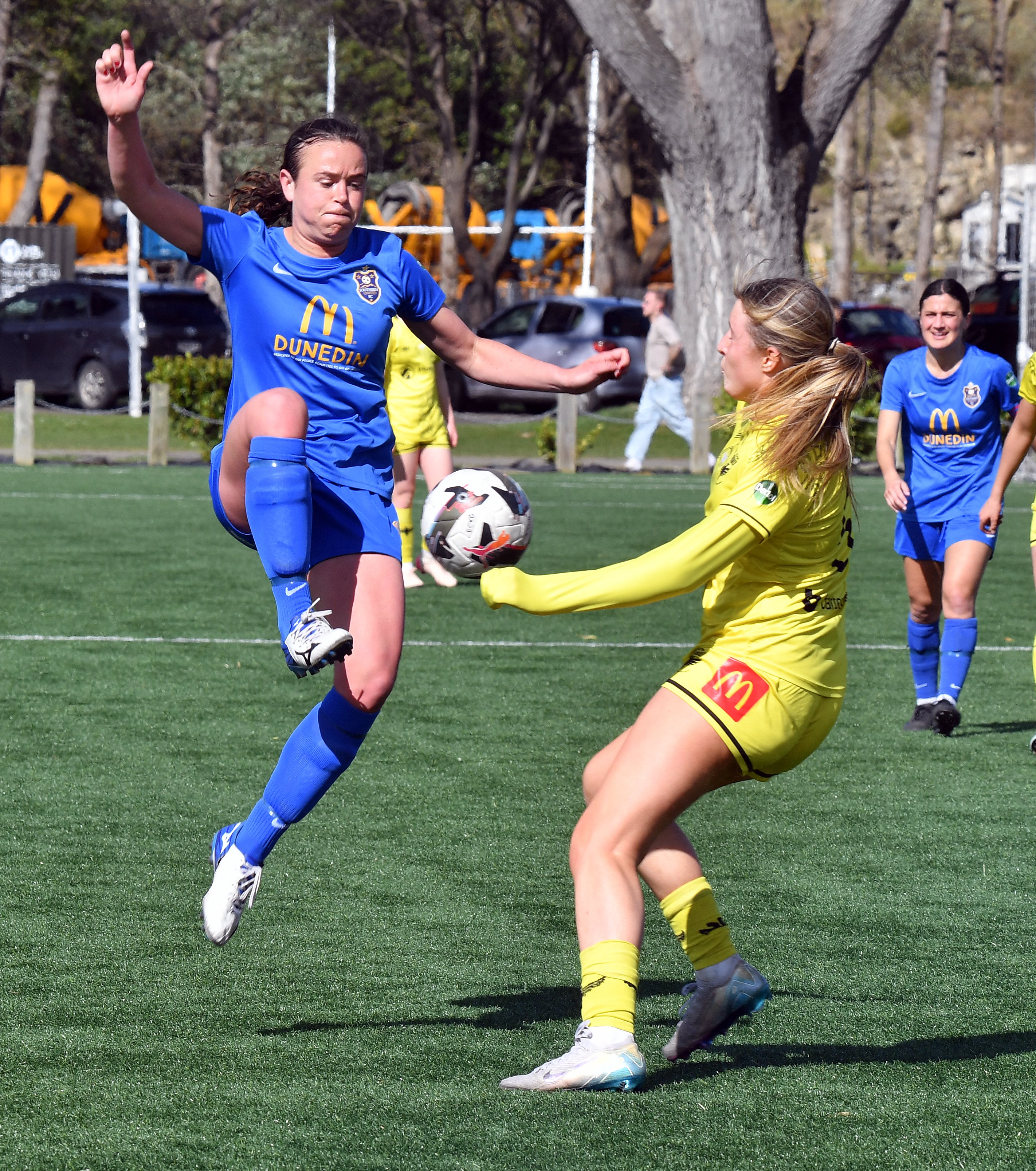 Southern United forward Georgia Nixon goes aerial to keep the ball from Phoenix Reserves defender...