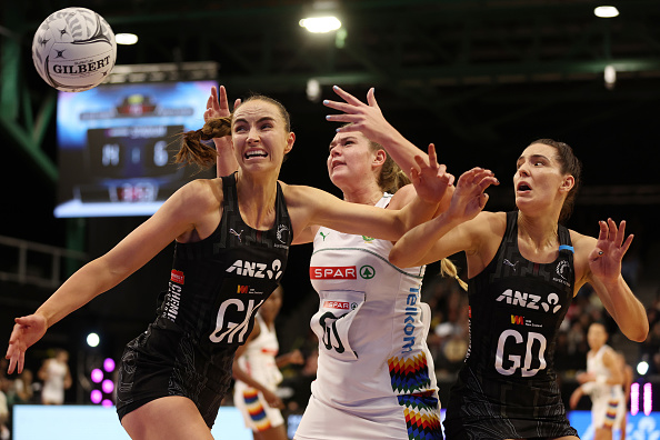Karin Burger (left) and Kelly Jackson (right) of New Zealand go for the rebound from Rolene...