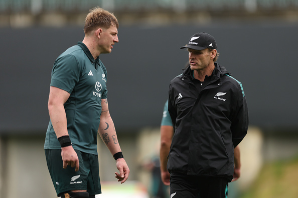 Fabian Holland, pictured with coach Scott Robertson, has been restored to the All Blacks starting...