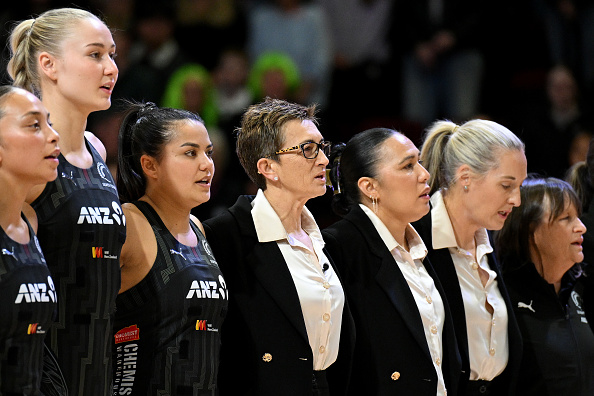 Yvette McCausland-Durie (centre) stands with the Silver Ferns for the national anthem in...