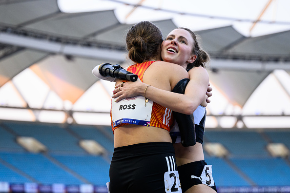 Otago runner Anna Grimaldi (right) embraces German rival Jule Ross after the women’s Y47 100m...