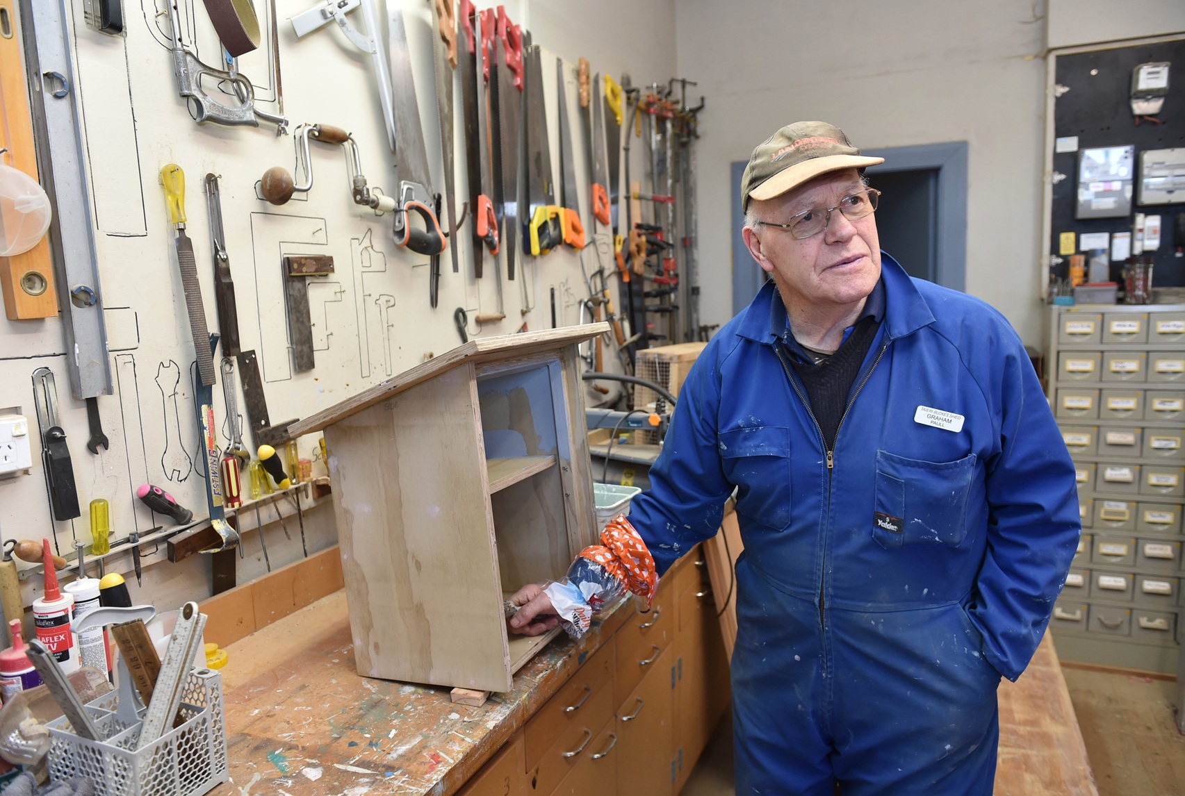 Taieri Blokes Shed member Graham Paull paints a Lilliput Library, one of 300 the shed team have...