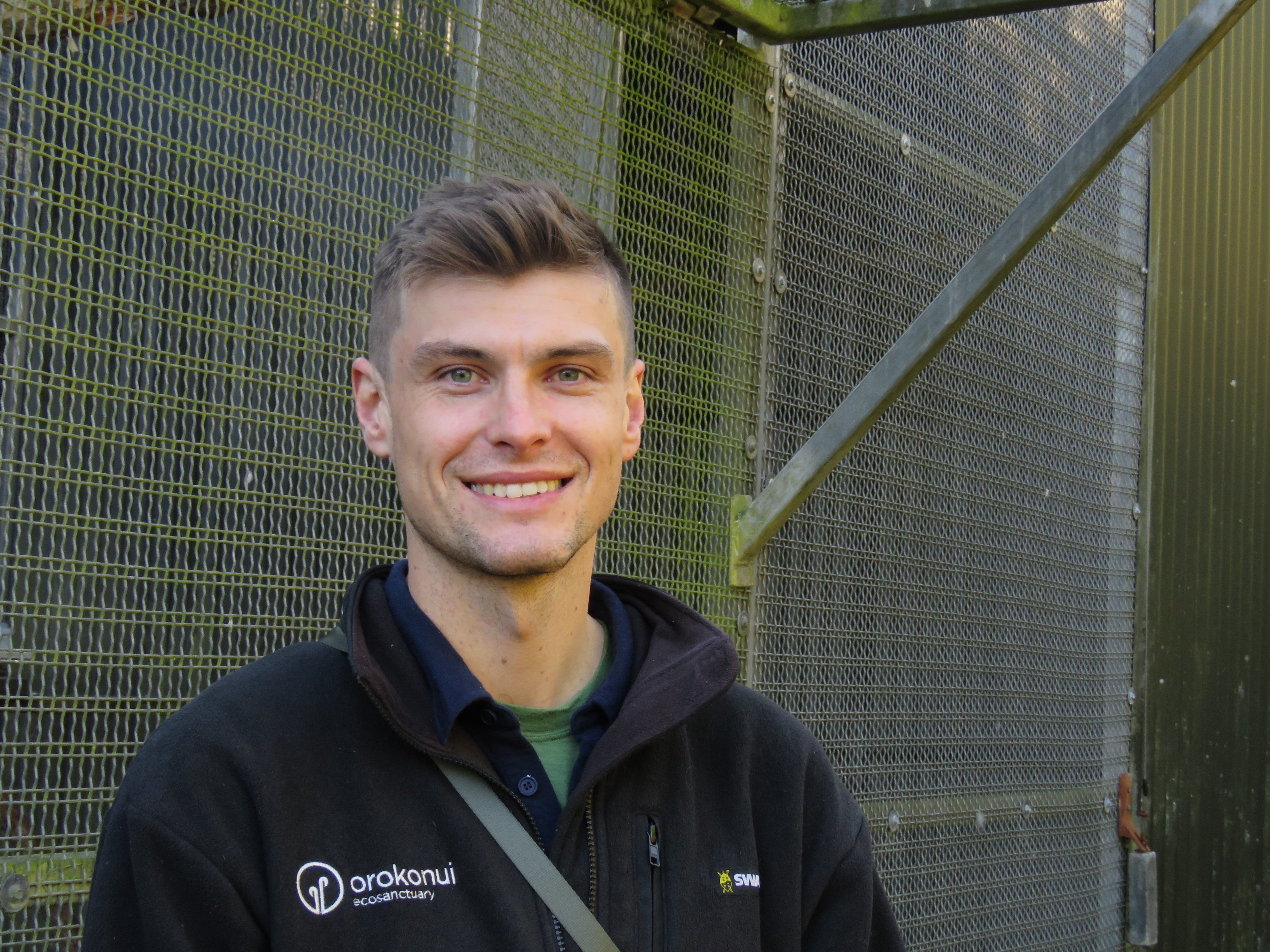 Communications and advocacy lead for Orokonui Ecosanctuary Taylor Davies-Colley by the kākā...