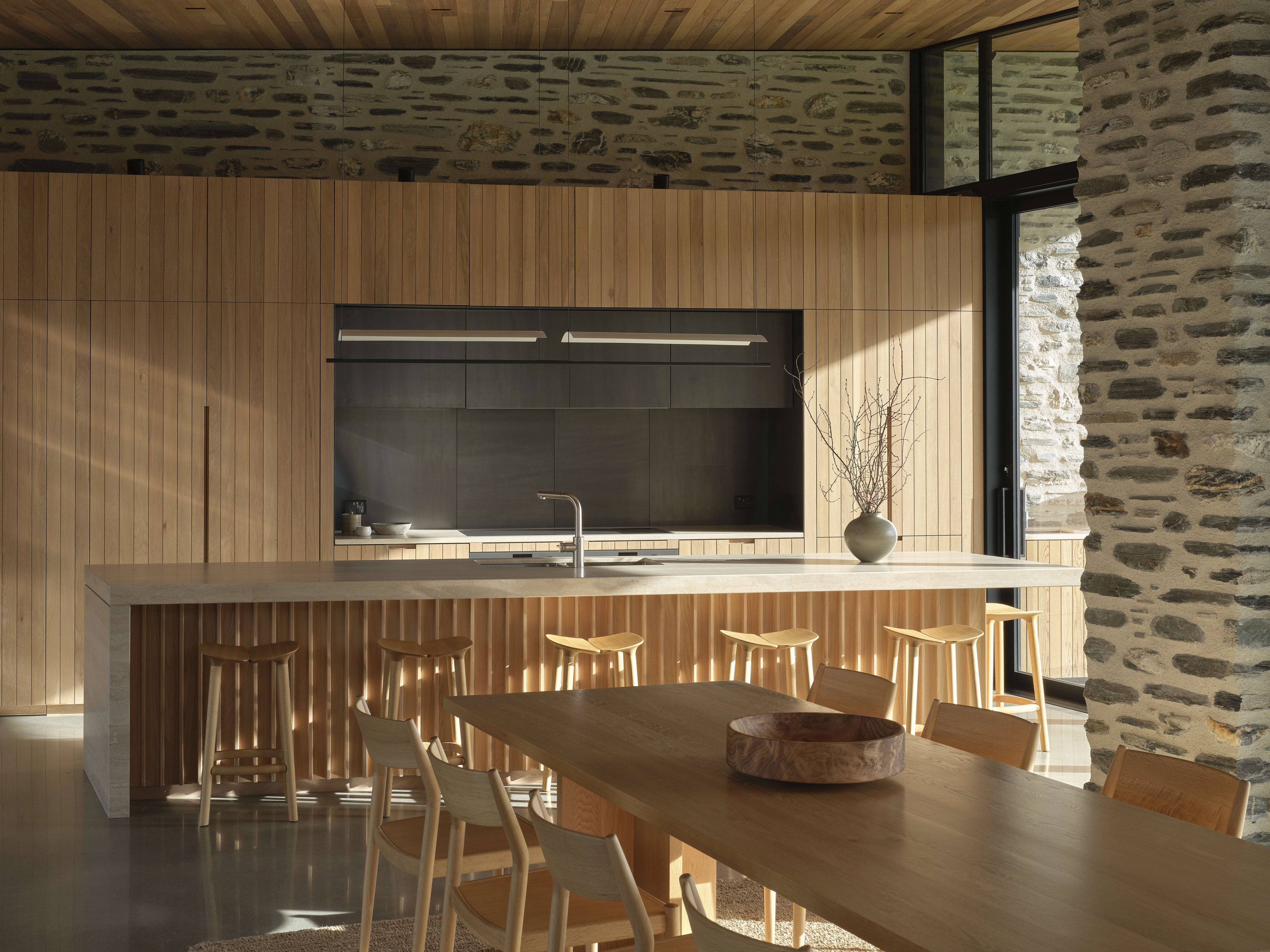 With outdoor terraces off either side, the kitchen is a social space. The scullery is almost...