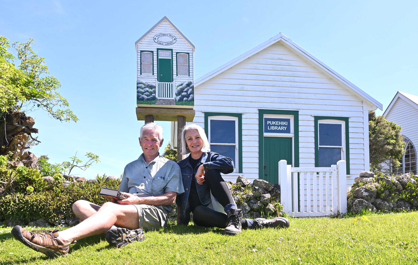 Pukehiki's already diminutive public library has a Lilliput companion. Seated outside are Hugh O...