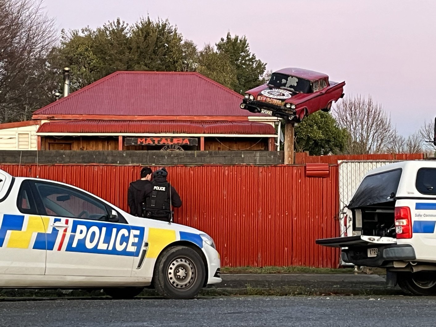 Armed police outside a gang property in Mataura in 2023. PHOTO: NEW ZEALAND POLICE

