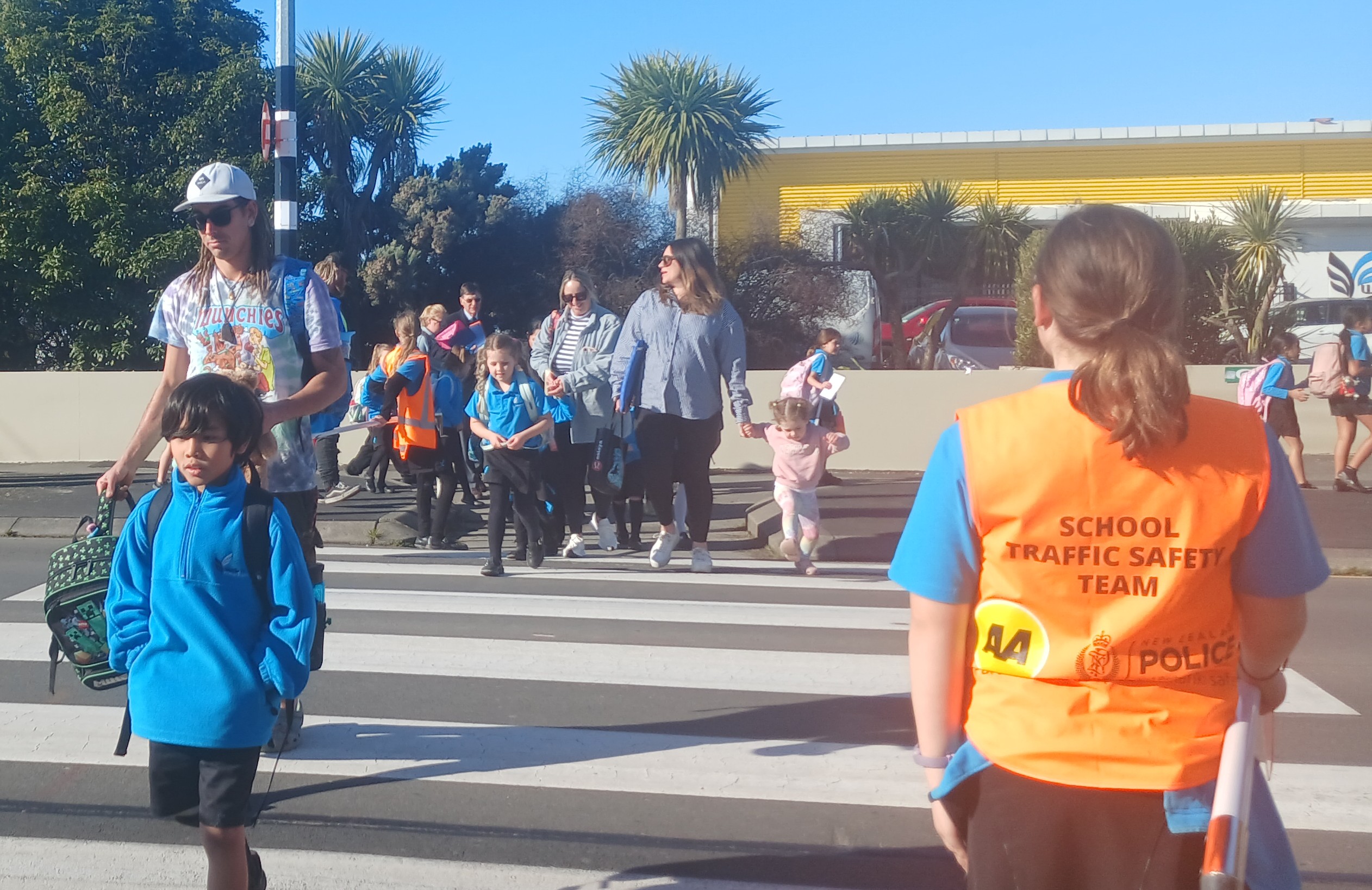 Waitākiri Primary pupils crossing the road outside school at 3pm, guided by the road patrol....