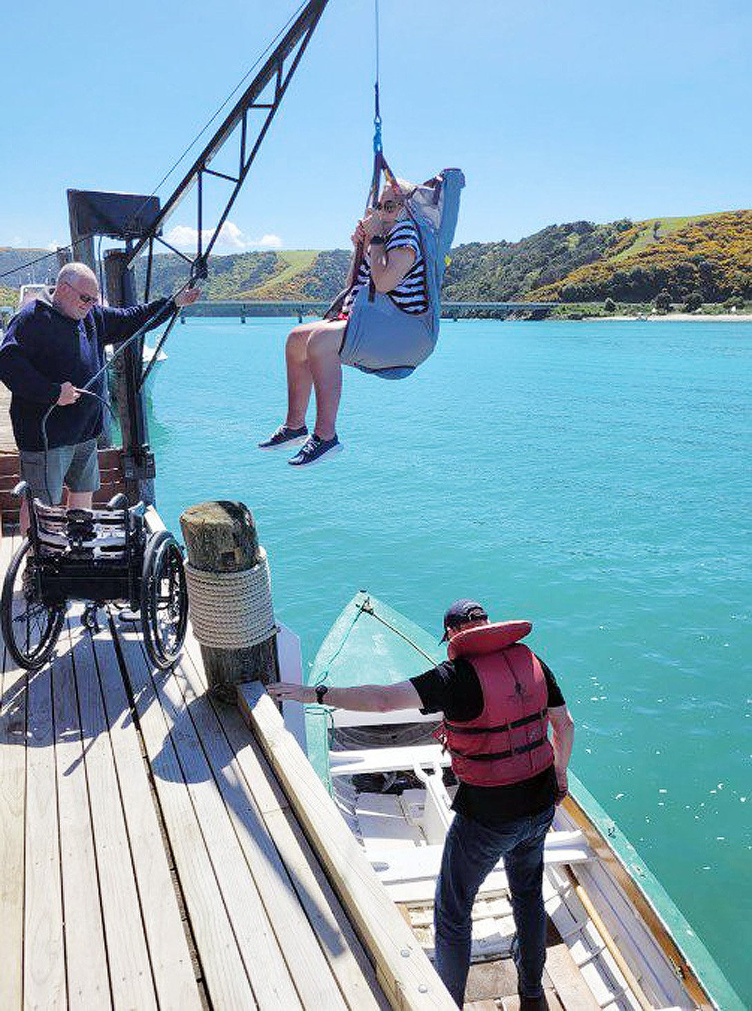 Sally Barkman is hoisted into a boat at Taieri Mouth. Photos: supplied