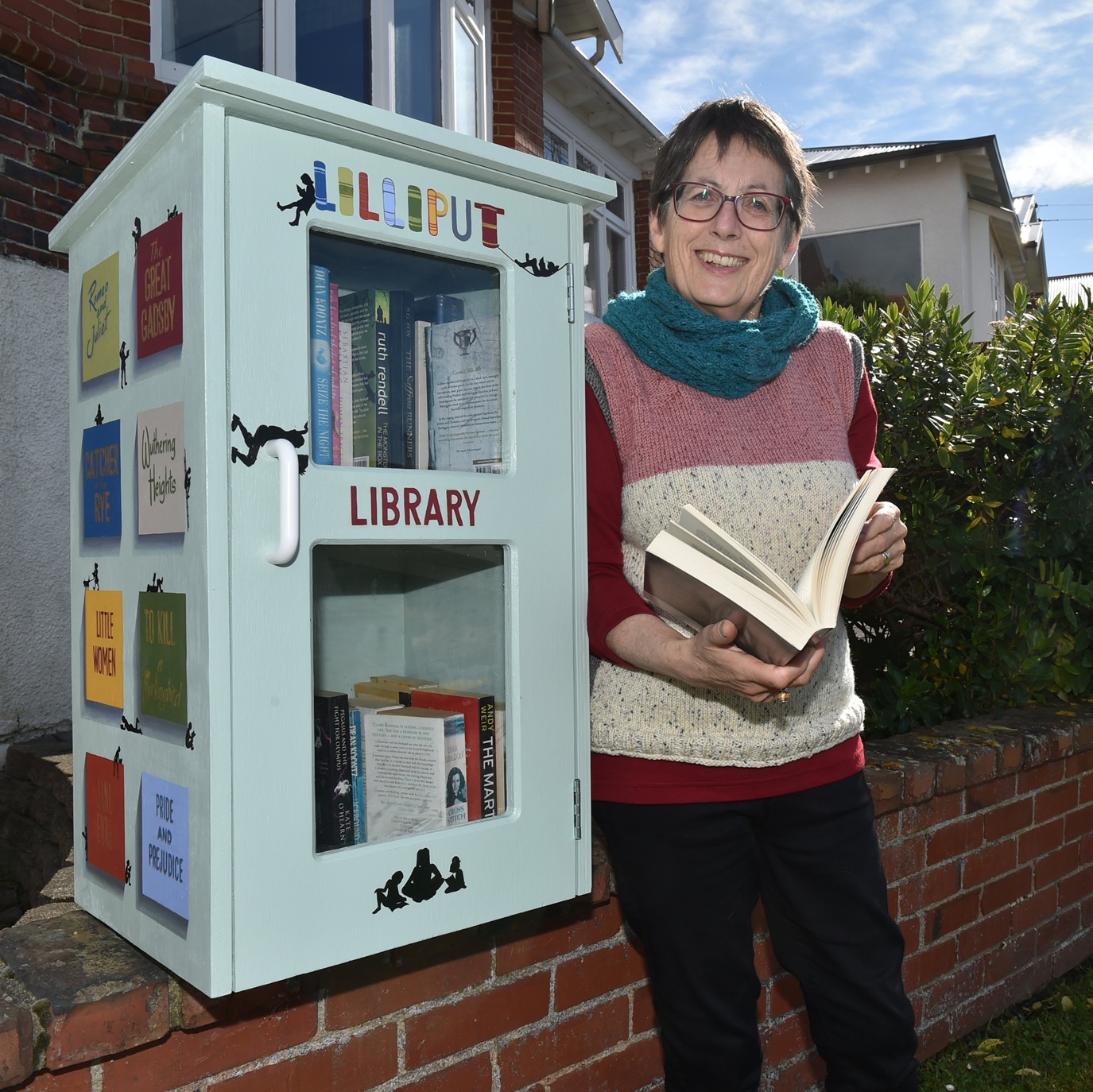 Ruth Arnison checks out a book where Lilliput Libraries began, in Hunt St, Andersons Bay. Photo:...