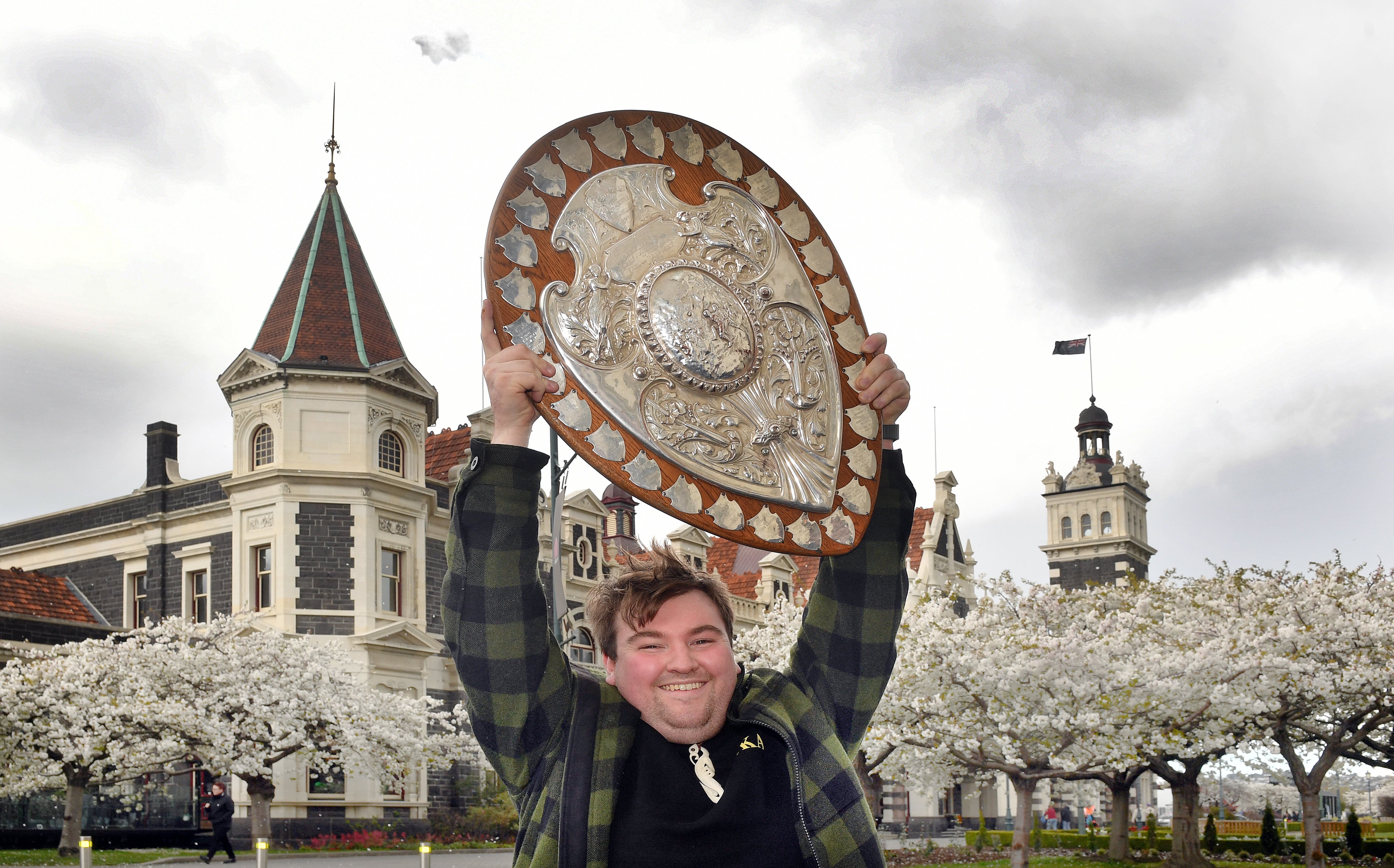 Rugby fan Joshua Stewart is all smiles with the Ranfurly Shield in Dunedin yesterday as he gets...