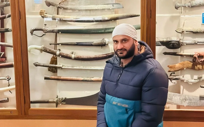 Narinder Singh Warraich in front of a display featuring the sword. Photo: Supplied