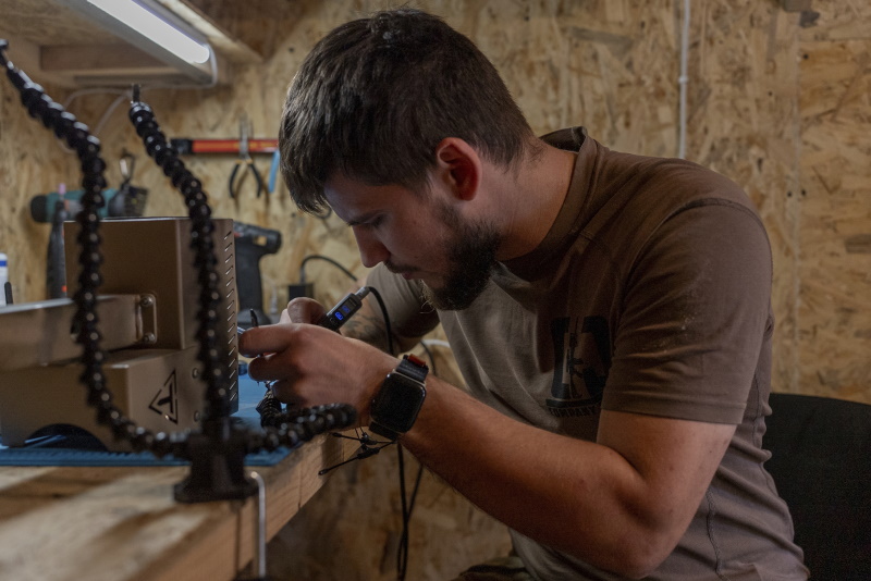 A Ukrainian serviceman known by the call sign "Miami" works on robotic military equipment near...