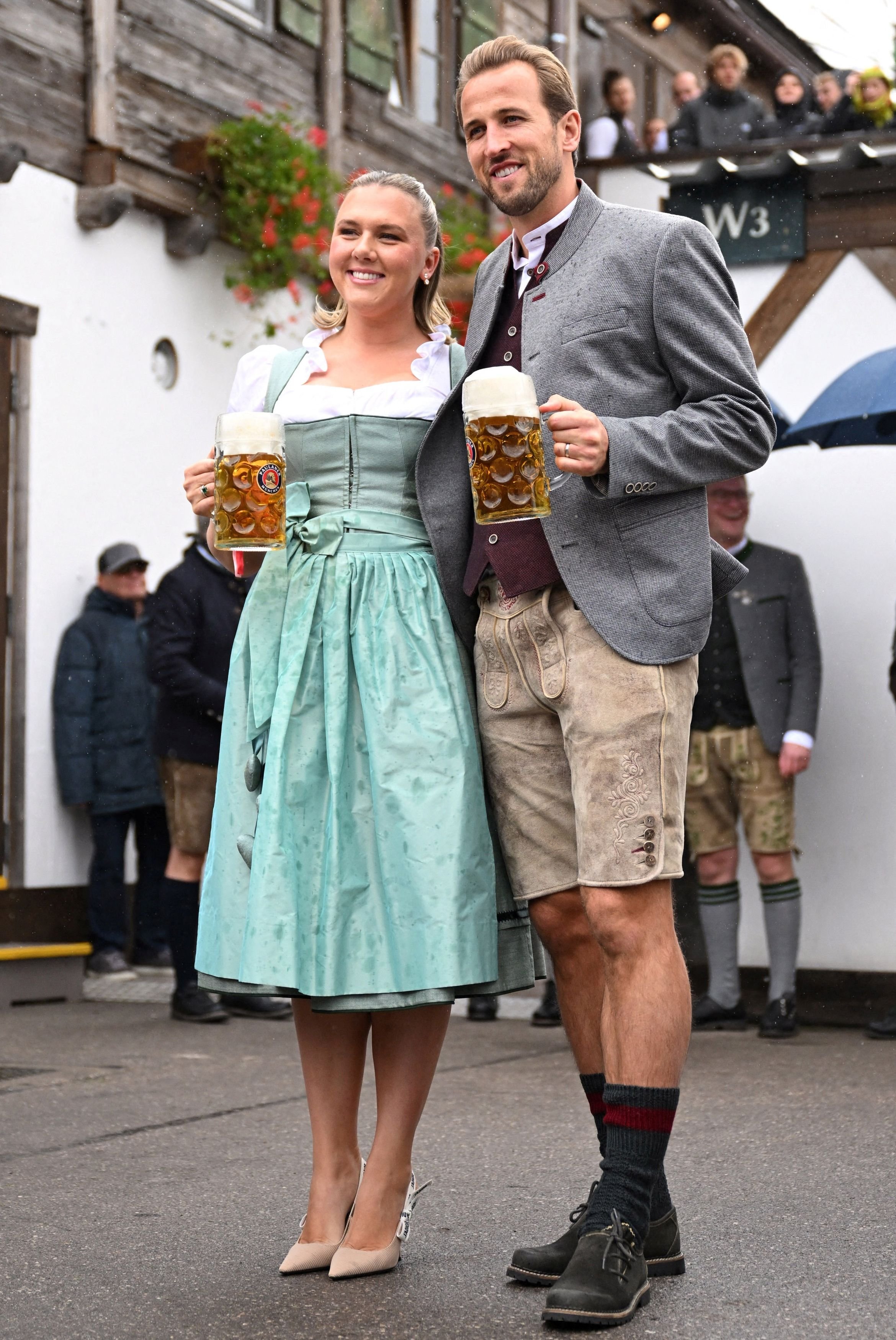 Bayern Munich and England striker Harry Kane and wife Katie Goodland embrace their time at the...