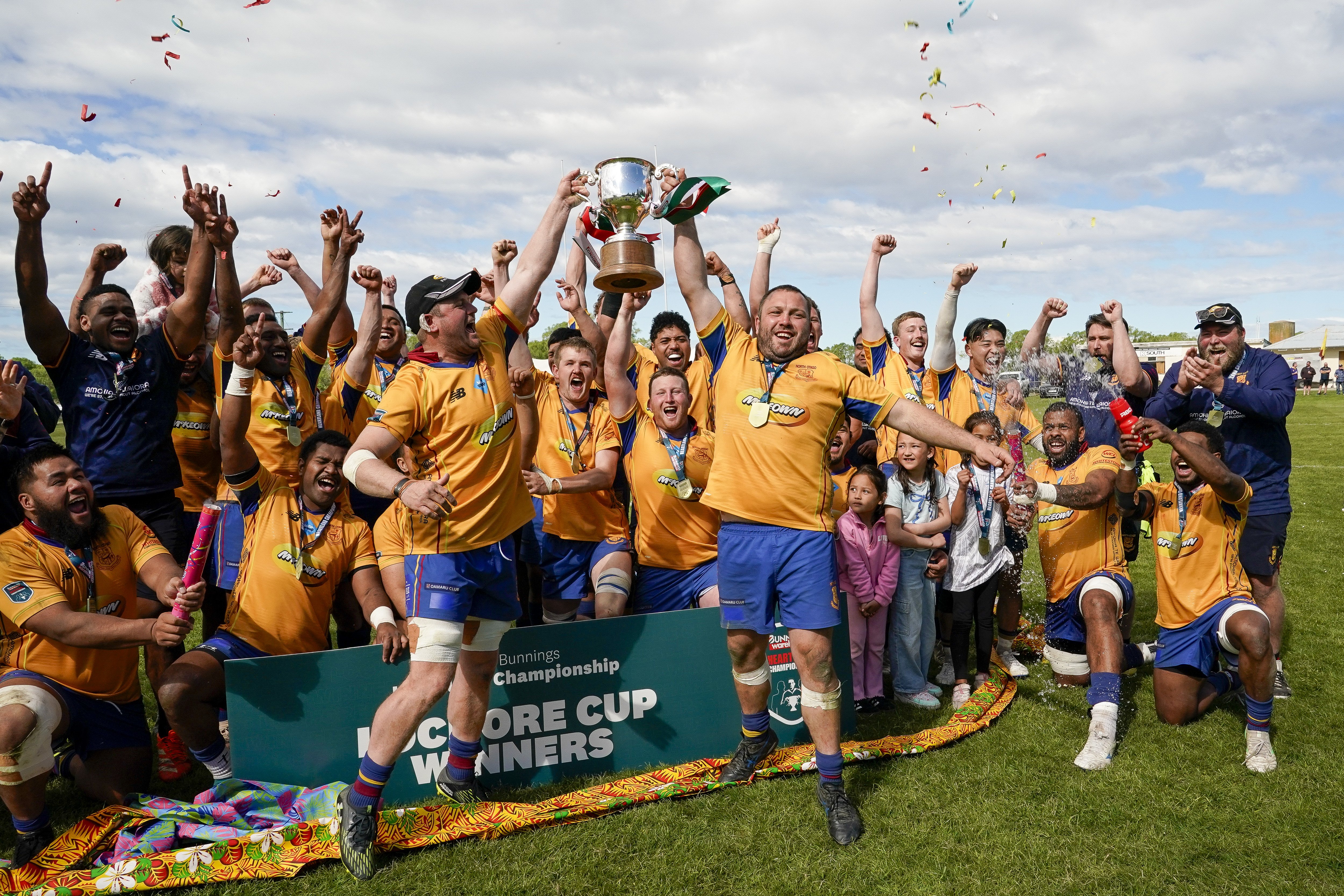 North Otago co-captains Cameron Rowland (left) and Hayden Tisdall lift the Lochore Cup after...