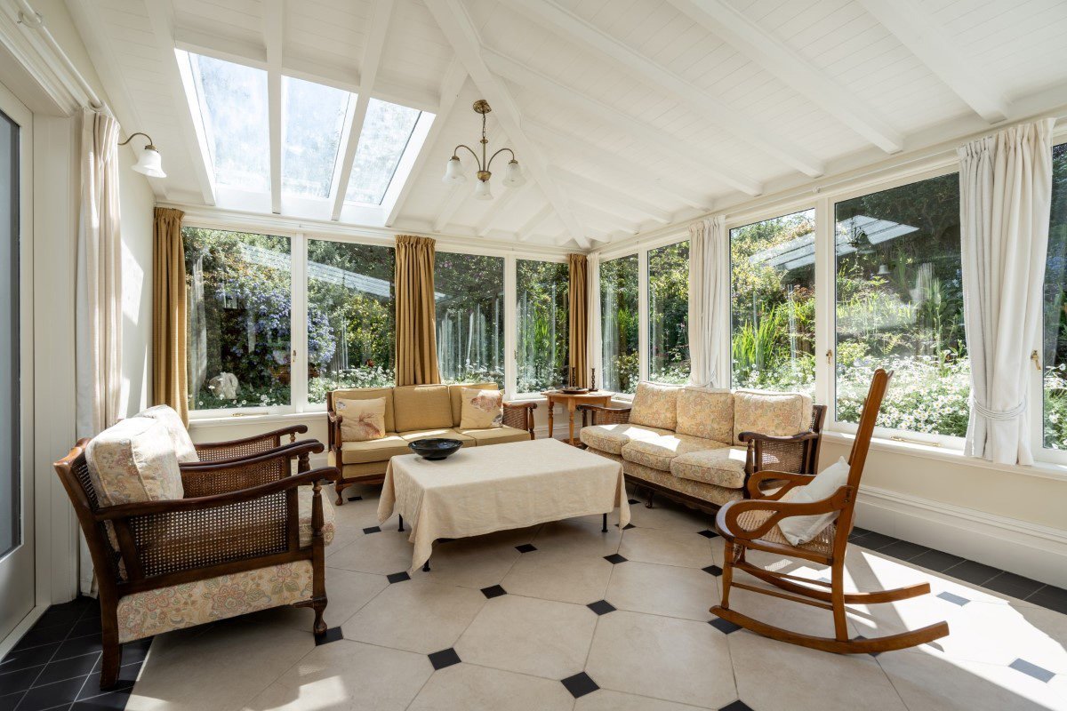 The north-facing conservatory along one side of the house has been the scene of many family...