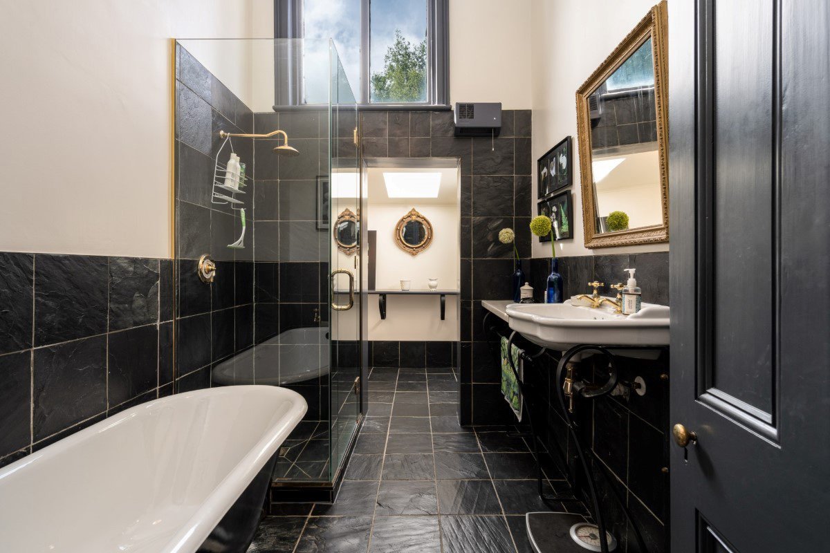 The main bathroom is tiled with black slate. Drs Cox and Sneyd enclosed the shower, put in a new...