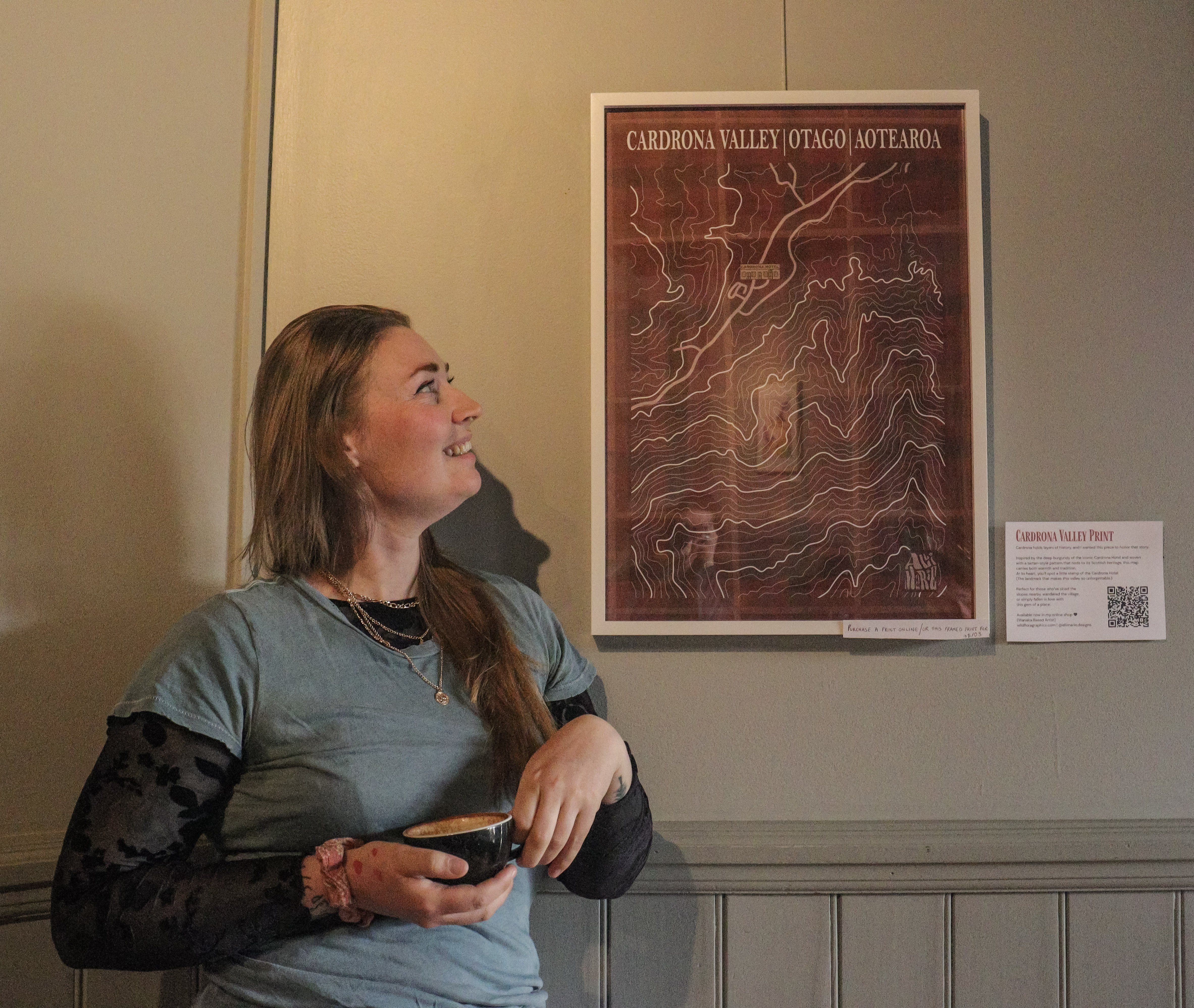 Artist Alli Marie with one of her artworks displayed at Relishes Cafe. PHOTO: RAWAN SAADI