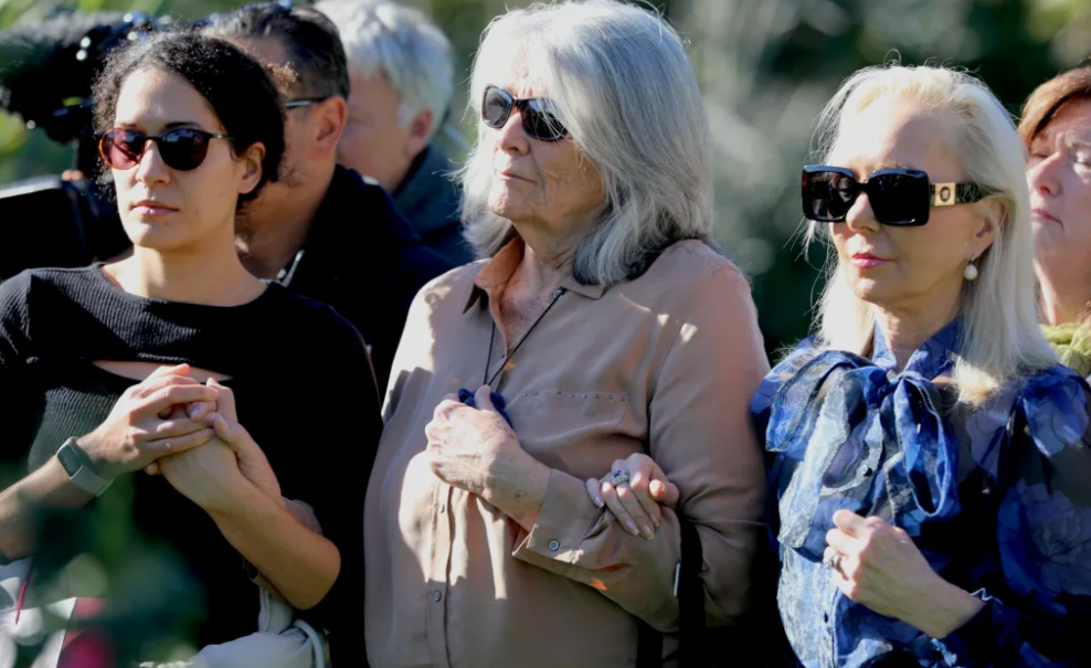 Carole Whorrall (centre) attending a service in memory of Kyle at St John's Reserve in Meadowbank...