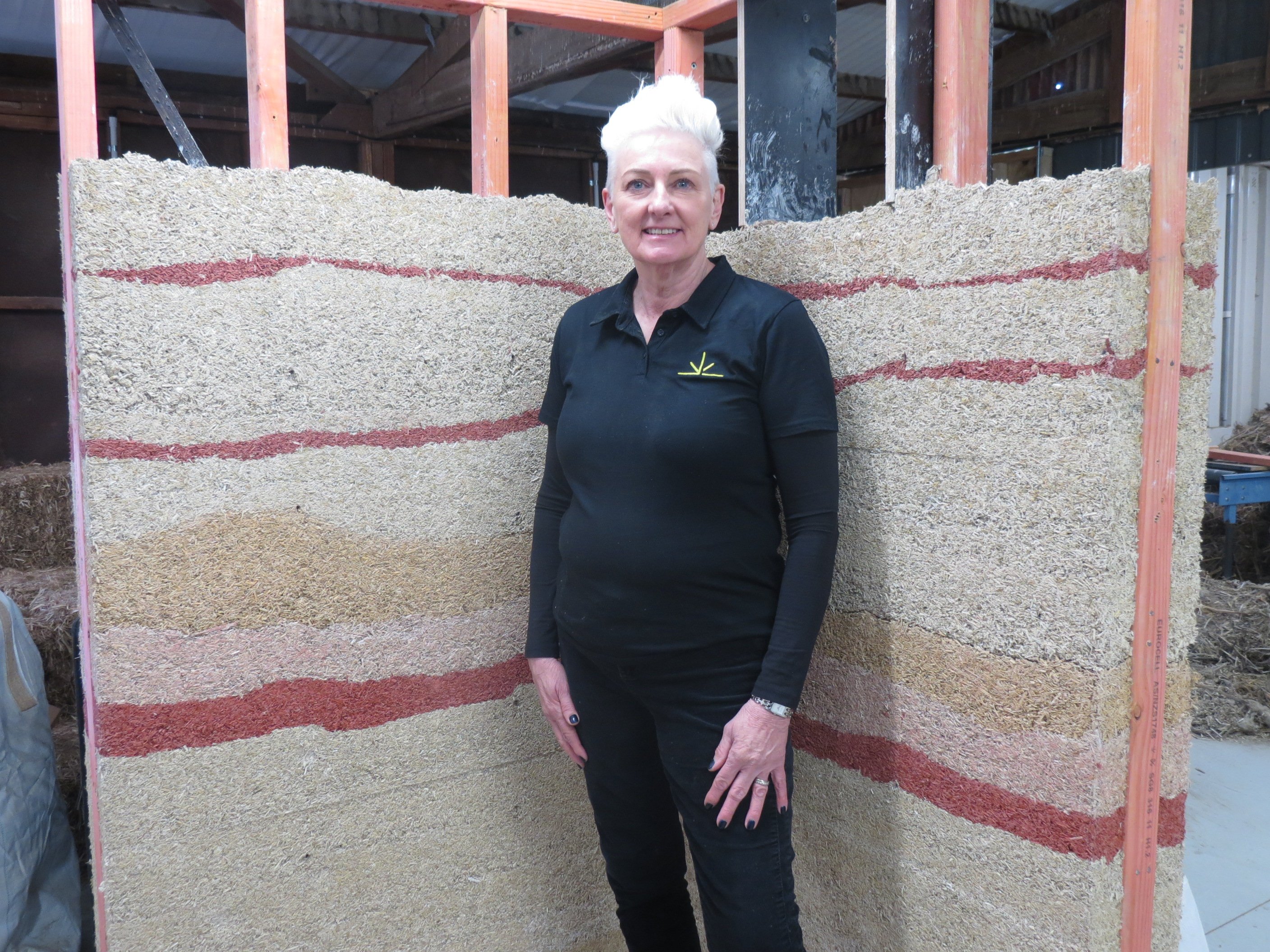 Hemp Central founder Tanya Simmonds stands in front of a wall made by layering hempcrete during...