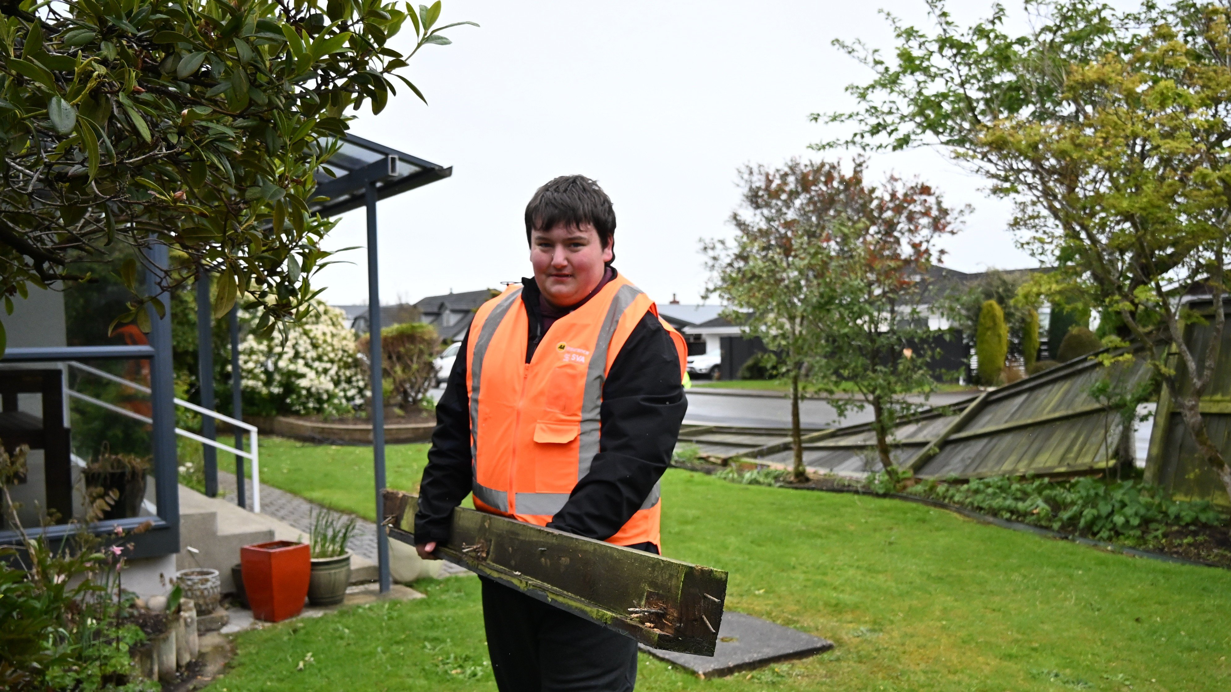 Southland Boys’ Student Volunteer Army ambassador Jacob Wilkinson-Hall carries a post from a...