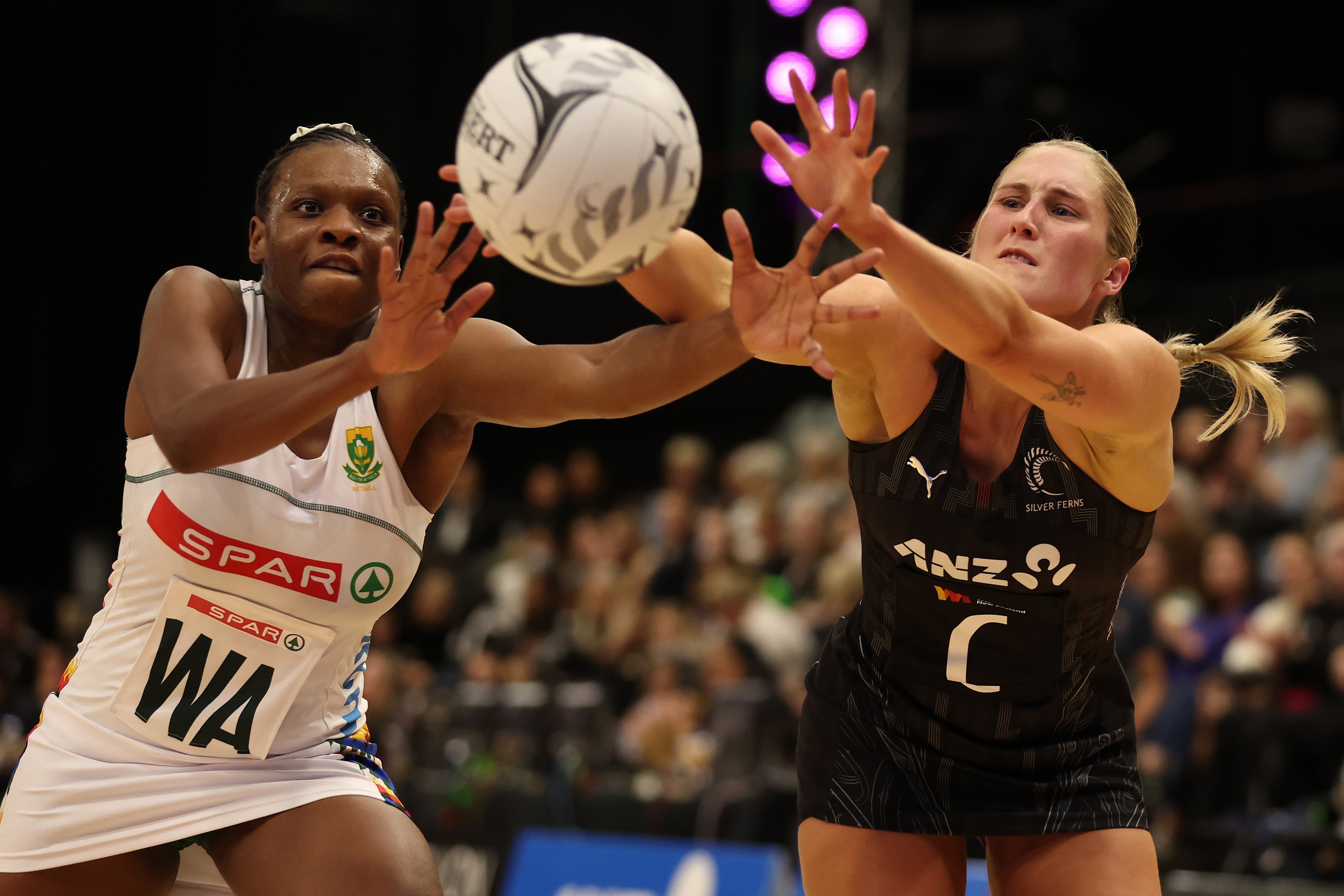South African captain Khanyisa Chawane contests possession with Silver Ferns midcourter Maddy...