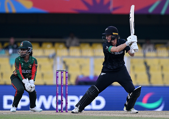 White Fern Sophie Devine plays a shot as Bangladesh wicket keeper Nigar Sultana Joty looks on....