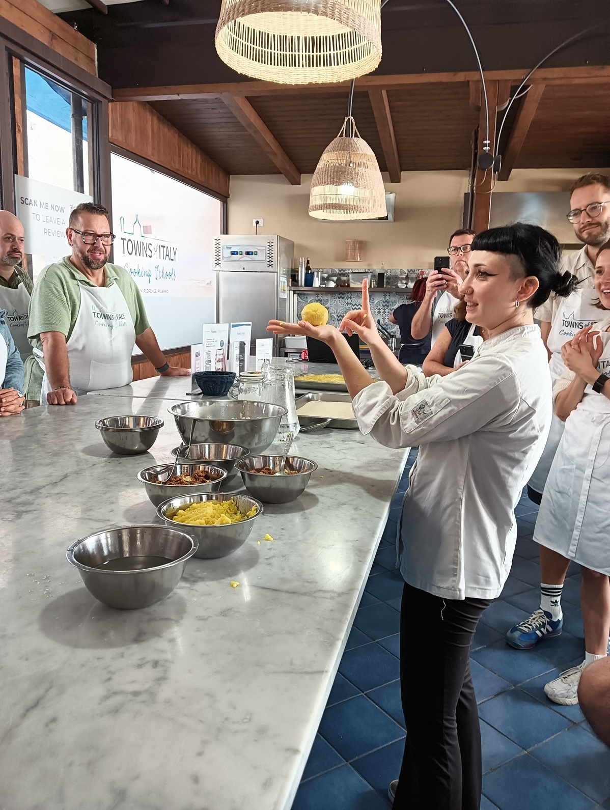 The chef shows how to roll arancine.