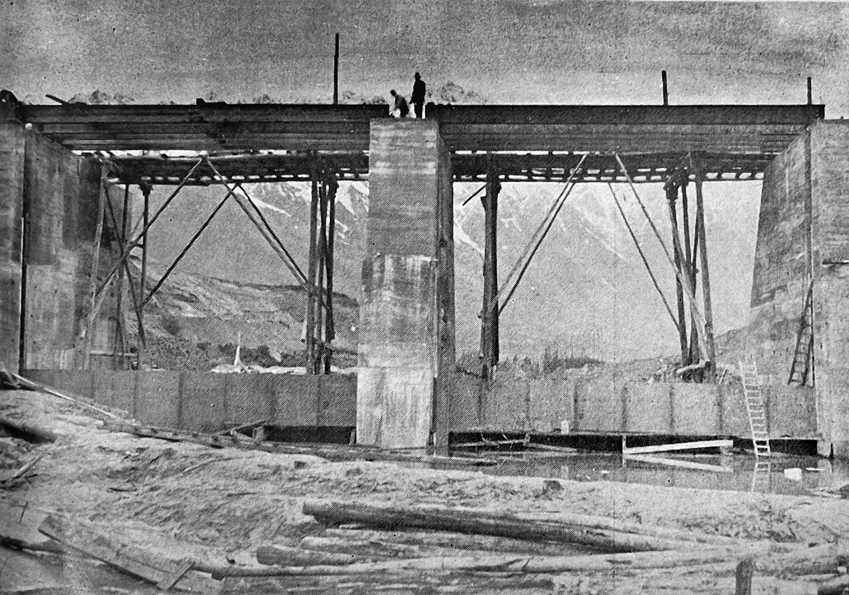 The first two floodgates are in position at the Kawarau Falls dam as construction of the road...
