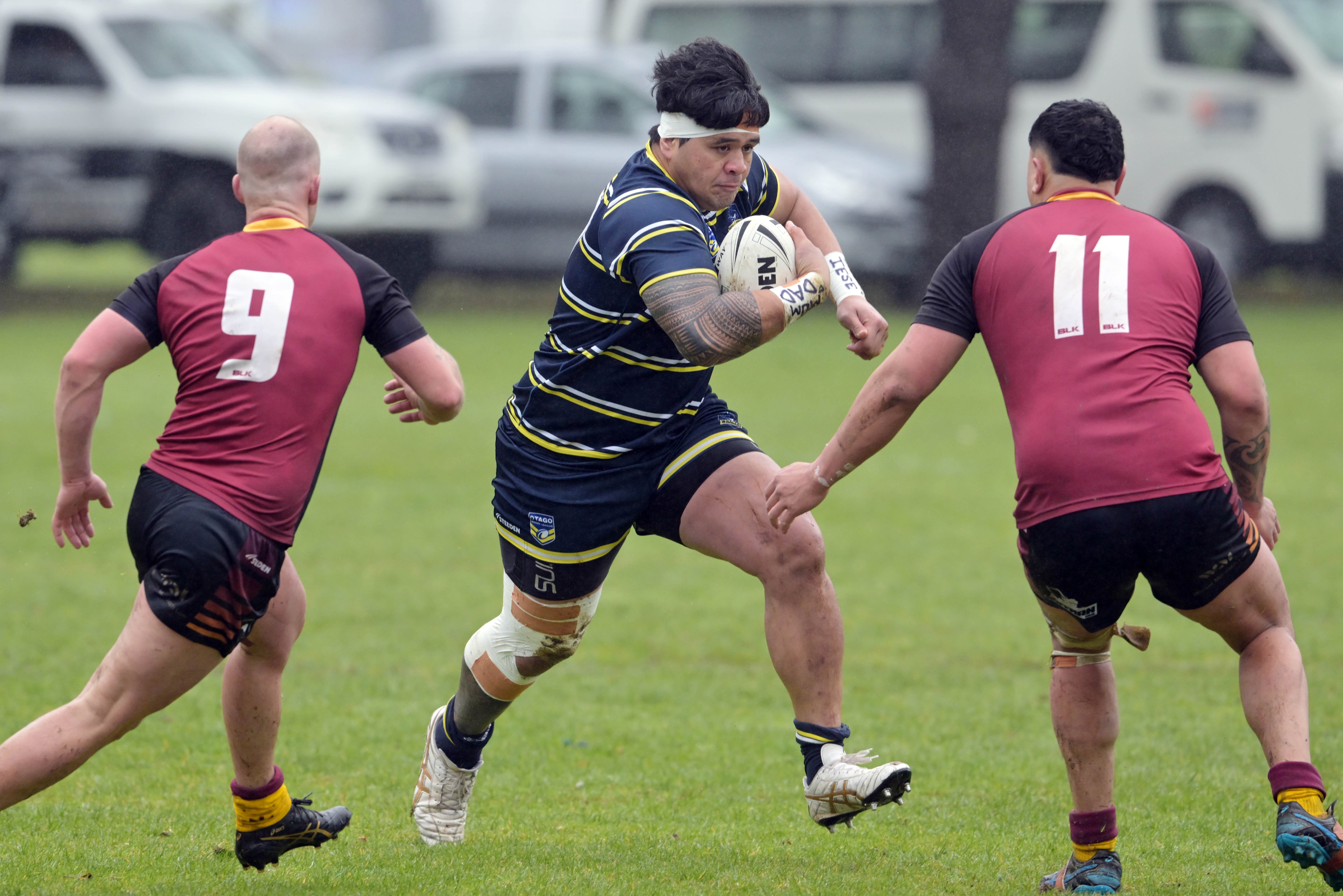 Otago Whalers forward Tofatuimoana Solia looks for a way through Southland defenders Calder White...