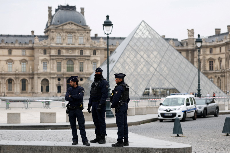 Police outside the Louvre following a robbery in which 'priceless' jewellery was stolen. Photo:...