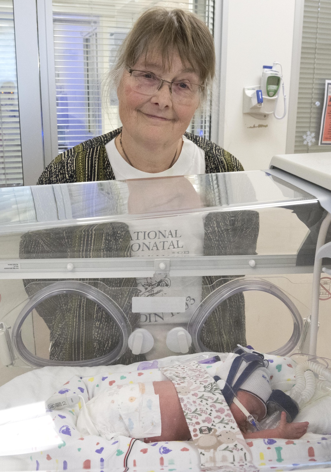 Recently retired neonatal intensive care unit nurse Sarah Gamble checks on 20-day-old Penelope...