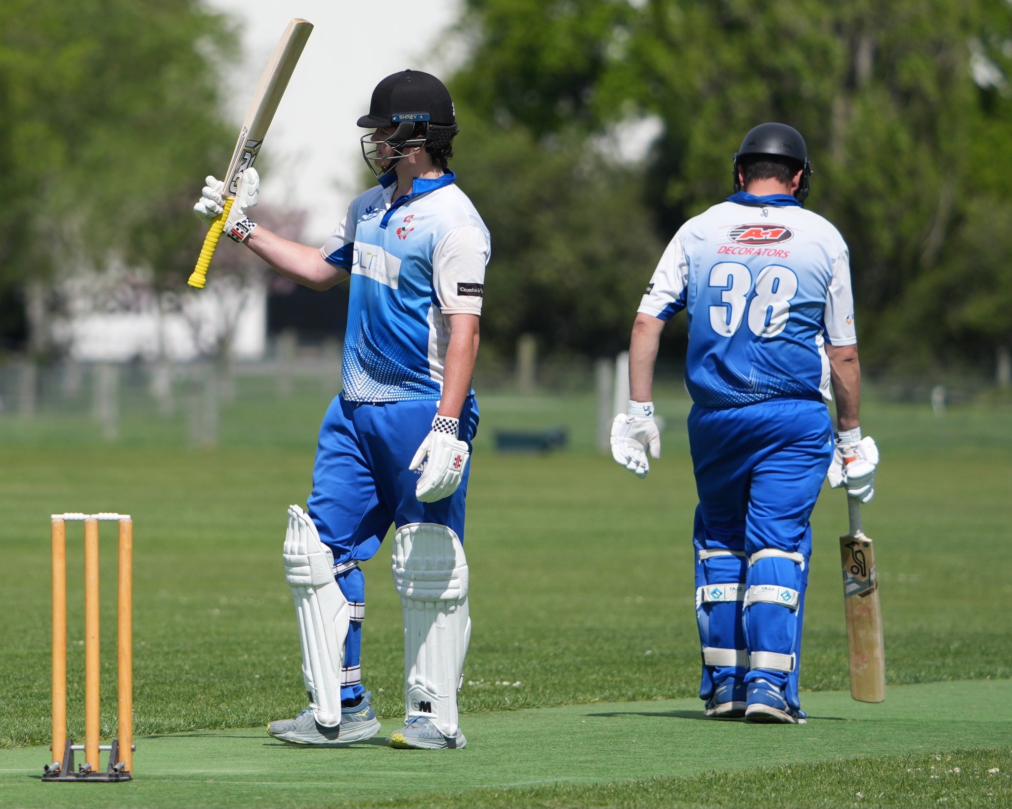 Union opening batter Thomas Anderson raises his bat after he brought up his half century in the...