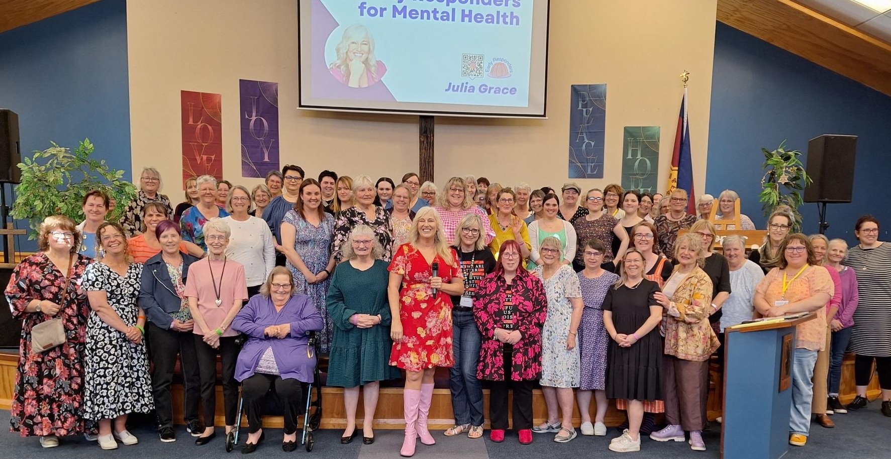 Attendees of the Be Kind to Your Mind women’s mental health conference with (front centre) guest...