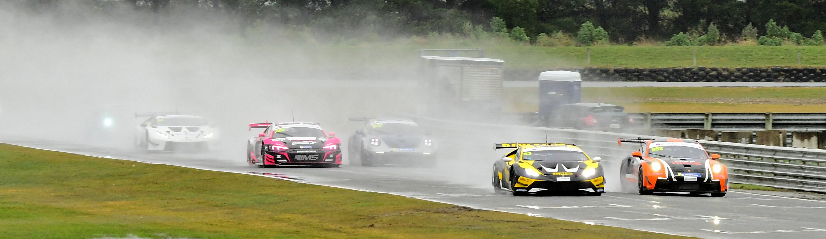 The Lamborghini Huracan driven by Brendon Leitch and Matt Day beside a Porsche 992 driven by...