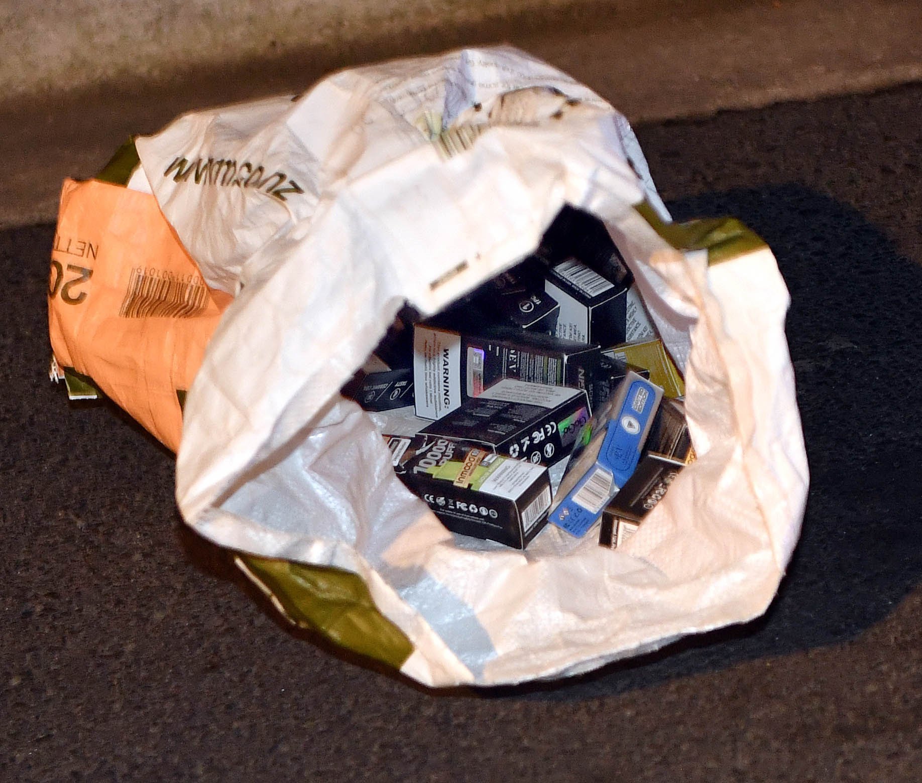 A bag of what appeared to be vapes was seen nearby.