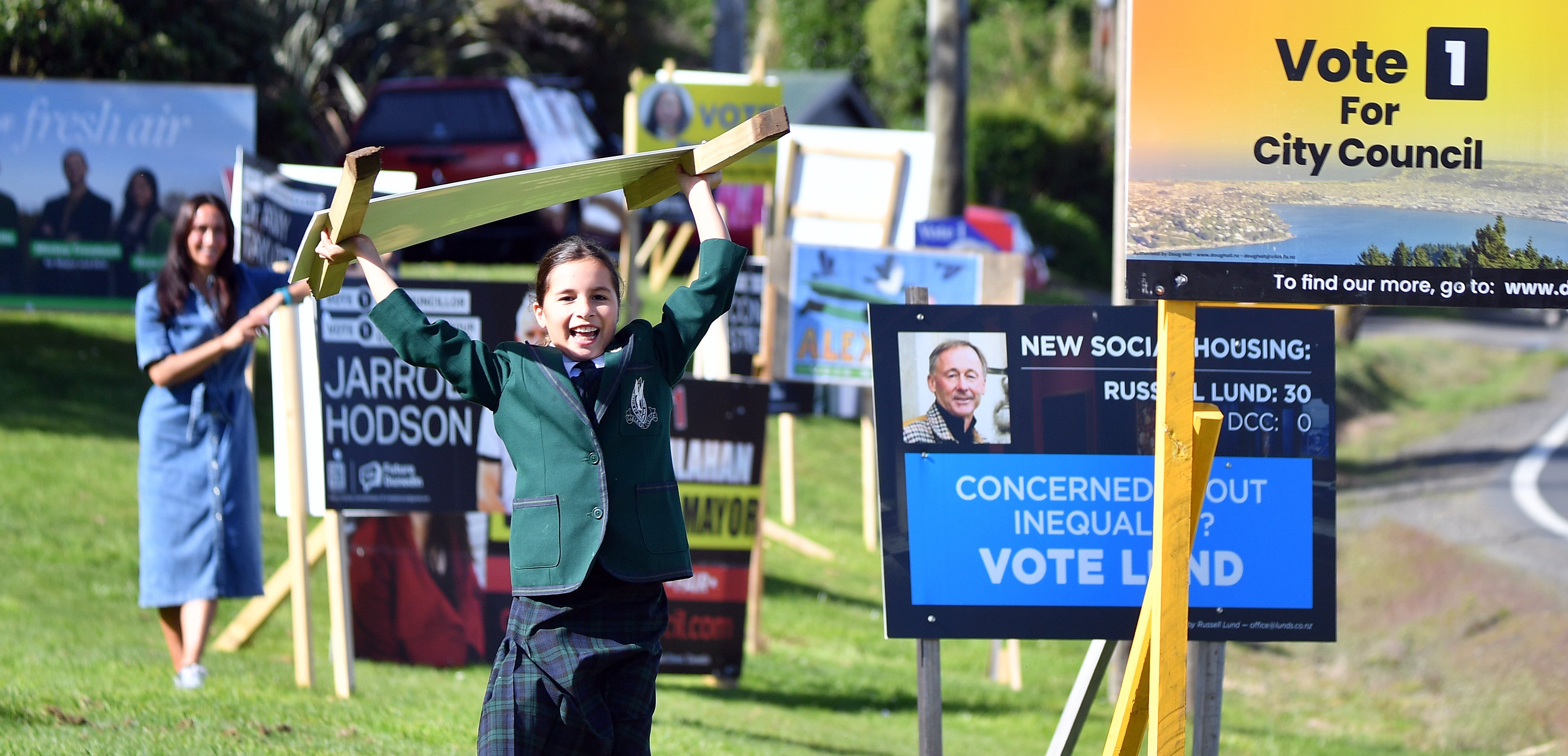 Otago Regional Council candidate Chanel Gardner (back left) suggests council candidate signs be...
