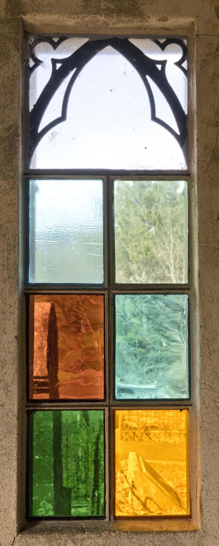 Replacement stained-glass window panes in the tomb. 