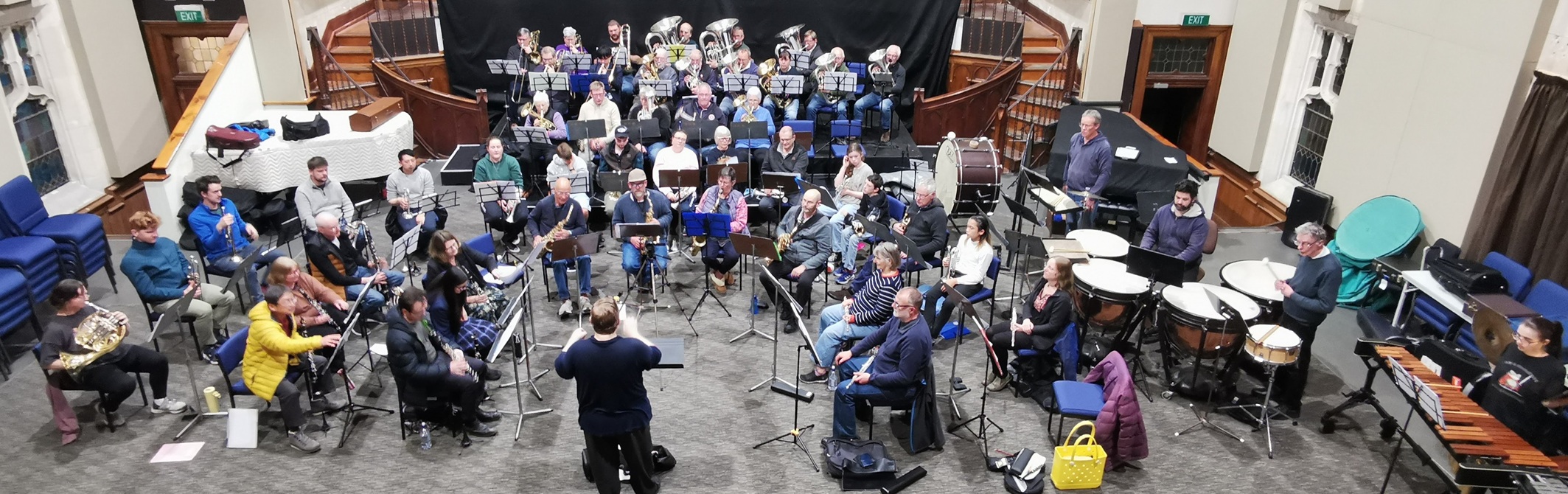 Dunedin City Wind Orchestra and Mosgiel Brass rehearse together, under the baton of Mark Anderson...