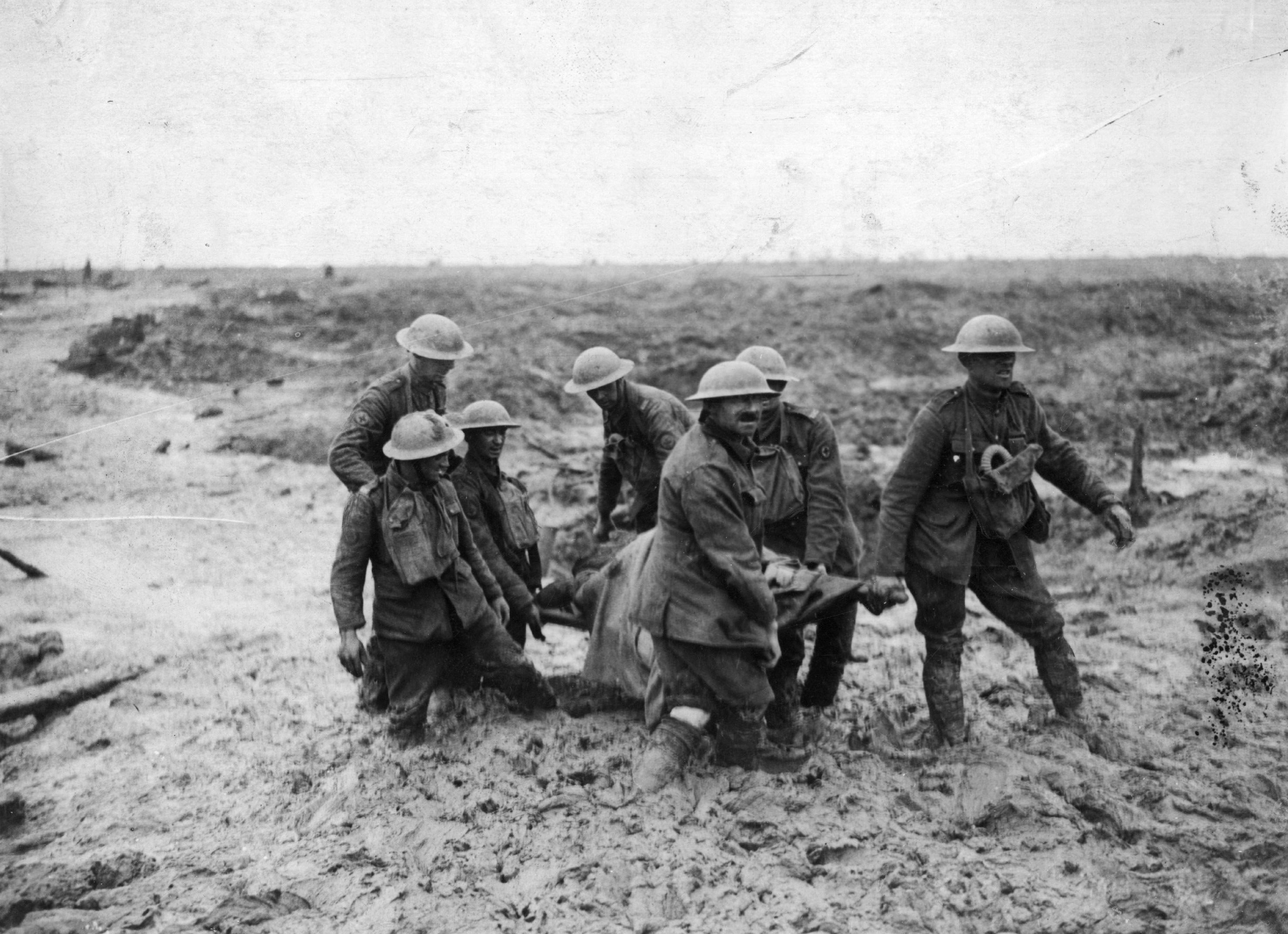 A stretcher-bearing party carrying a wounded soldier through the mud near Boesinghe during the...